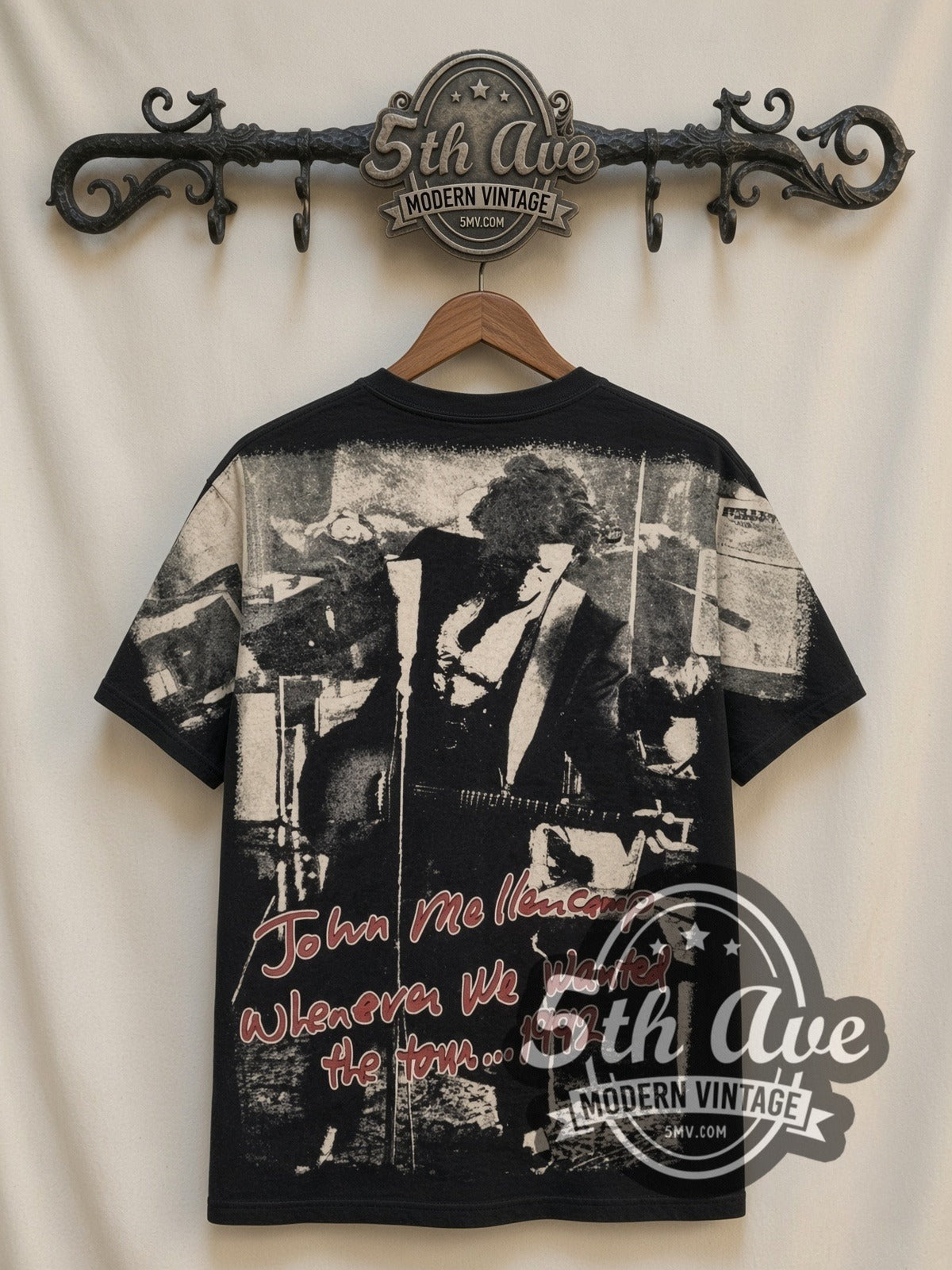 John Mellencamp Whenever We Wanted Tour 1992 all-over-print vintage band t-shirt in black, back view on a display rack