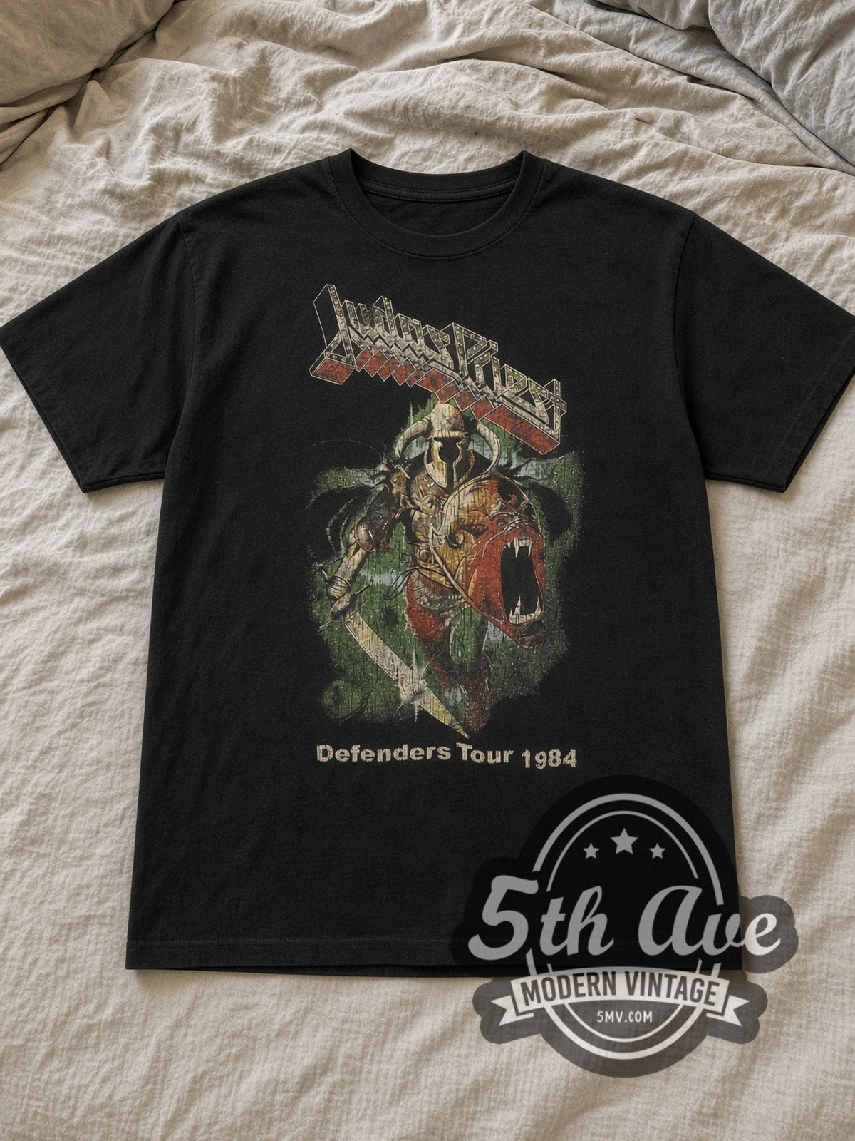 Black Judas Priest Defenders Tour 1984 Vintage Band T-Shirt laid flat on a linen bed