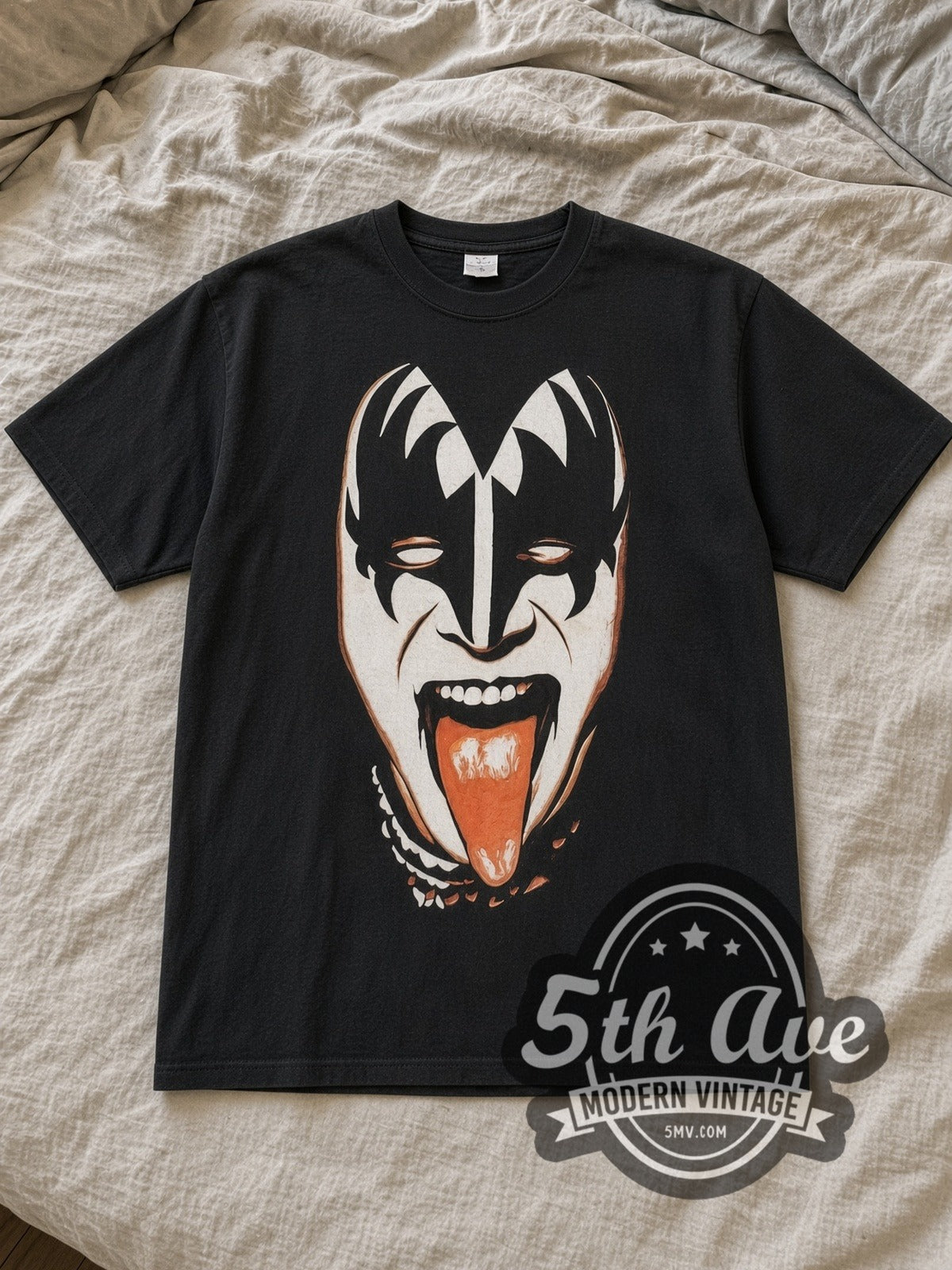 Black KISS Gene Simmons \m/KIϟϟ\m/ Vintage Band T-Shirt laid flat on a linen bed