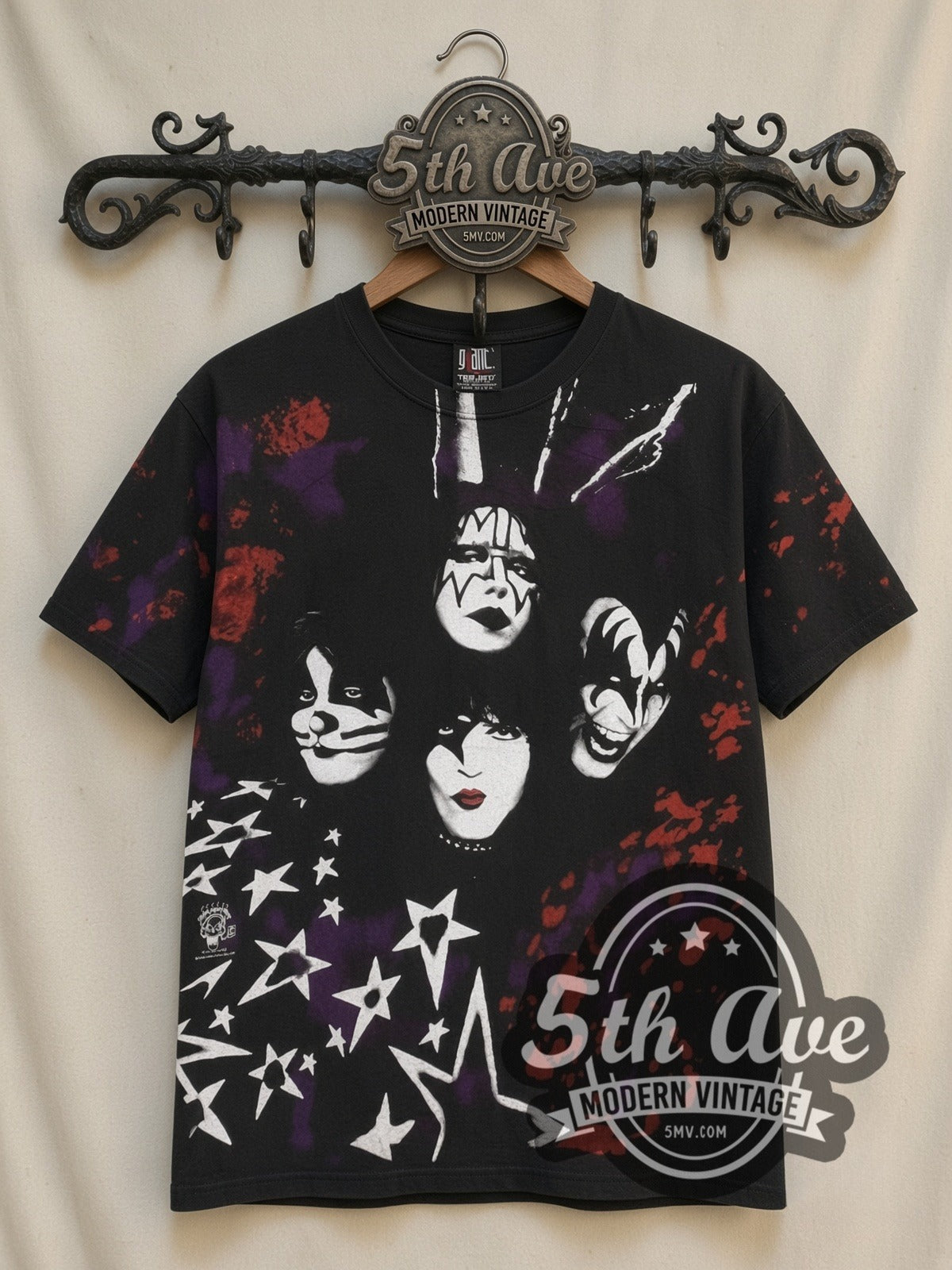 KISS Starfield Faces all-over-print vintage band t-shirt in black, front view on a display rack