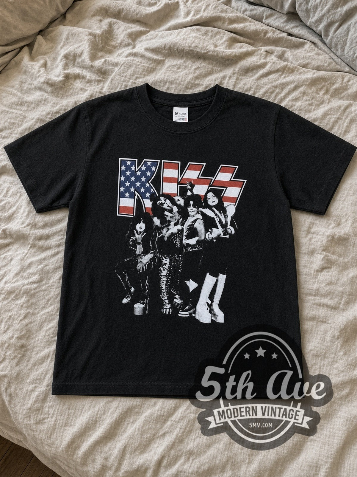 KISS Stars and Stripes Tiger Stadium kids band tee in black laid flat on a bed, front artwork