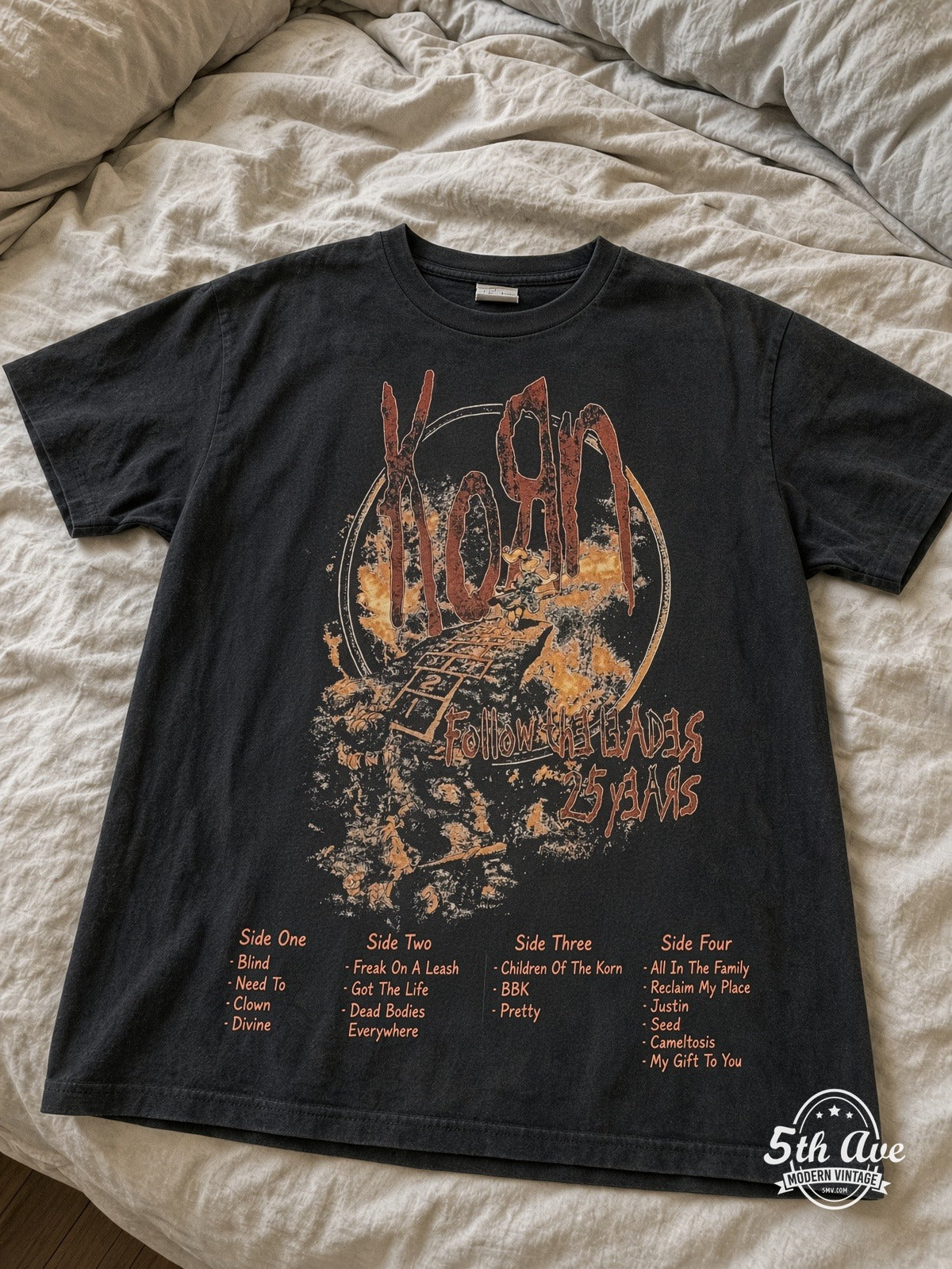 Korn Follow the Leader 25 Years vintage tee laid on bed