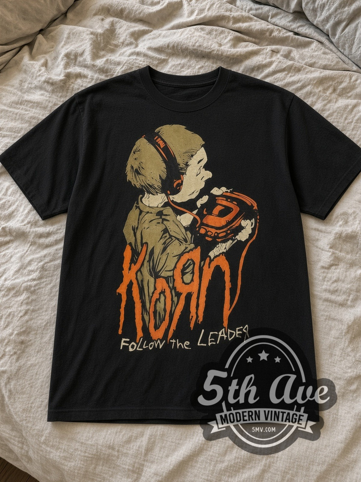 Black Korn Follow the Leader Vintage Band T-Shirt laid flat on a linen bed