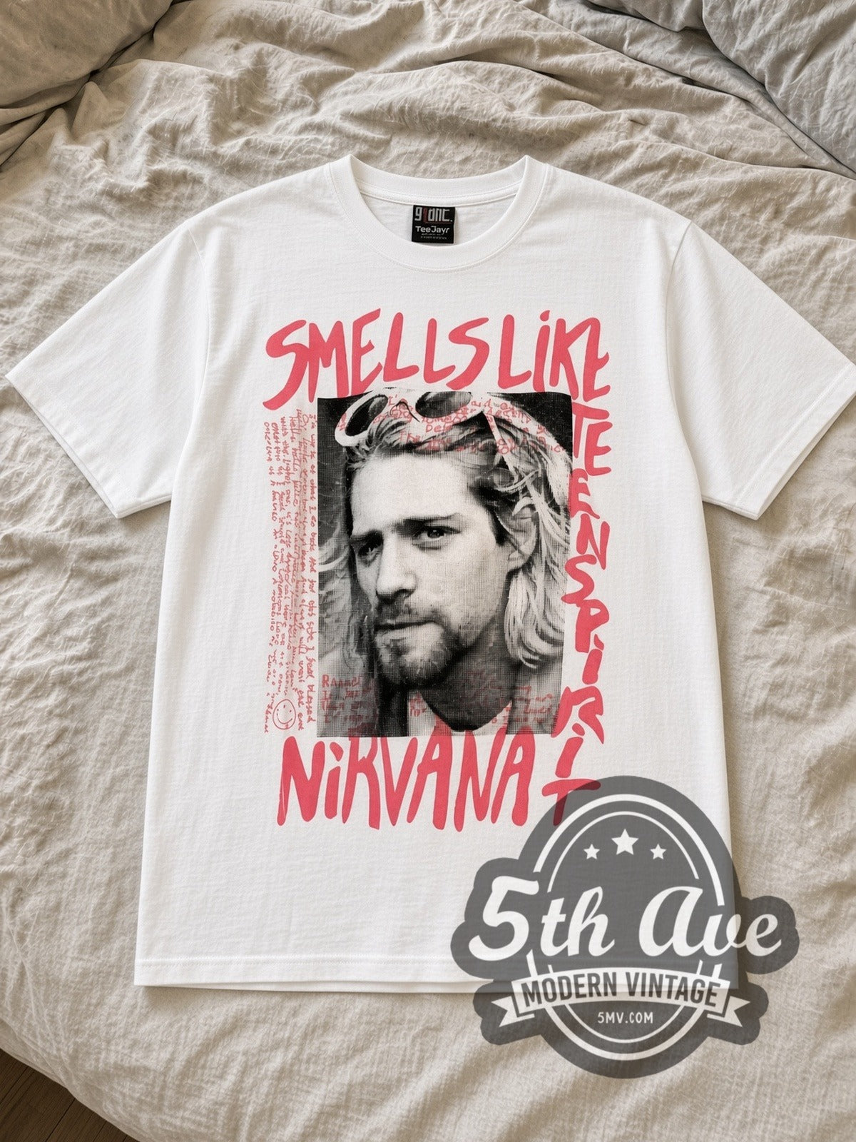 White Nirvana Kurt Cobain Nirvana Graphic Style Vintage Band T-Shirt laid flat on a linen bed