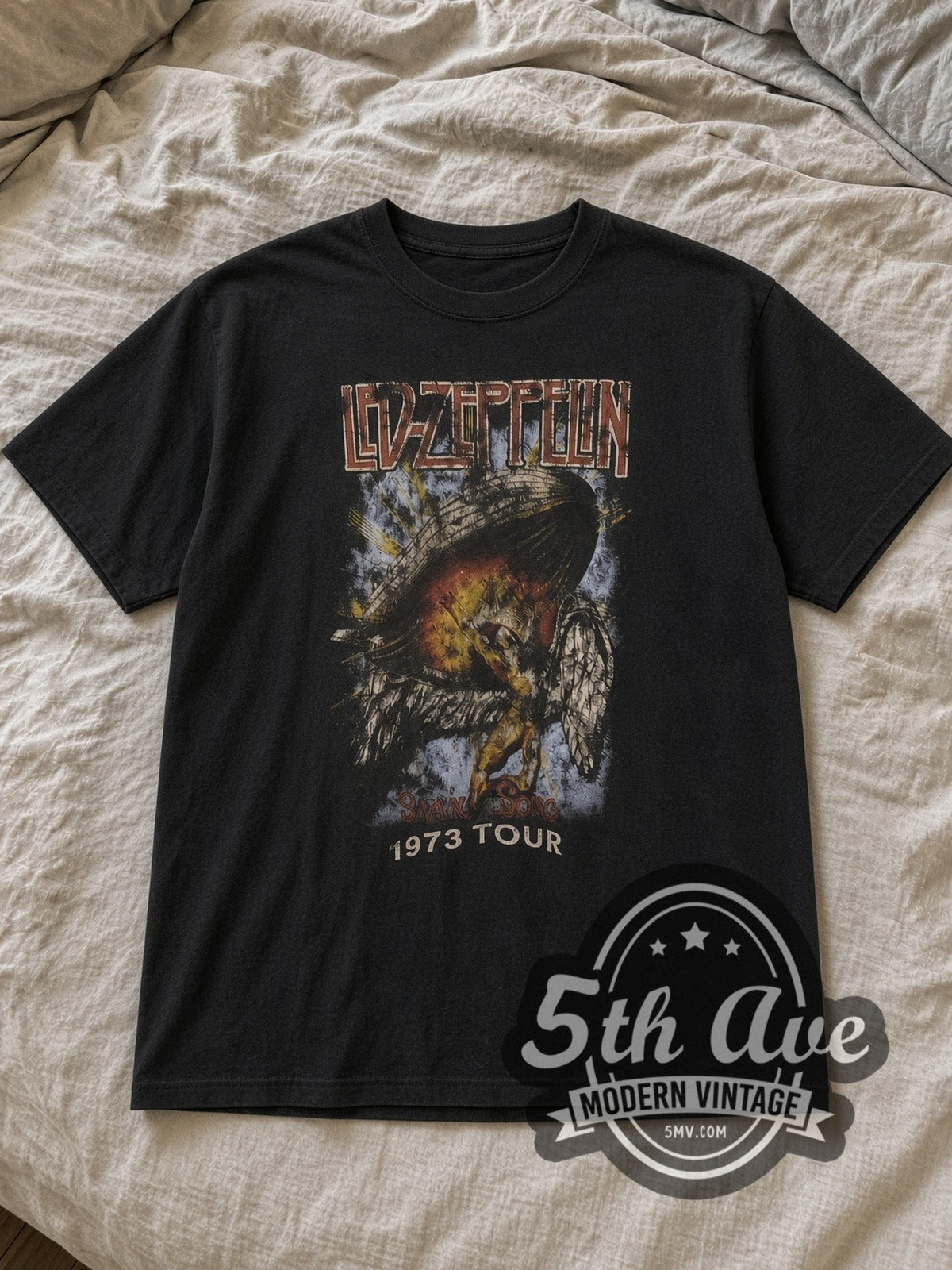 Black Led Zeppelin 1973 Tour Angel & Zeppelin Black Vintage Band T-Shirt laid flat on a linen bed