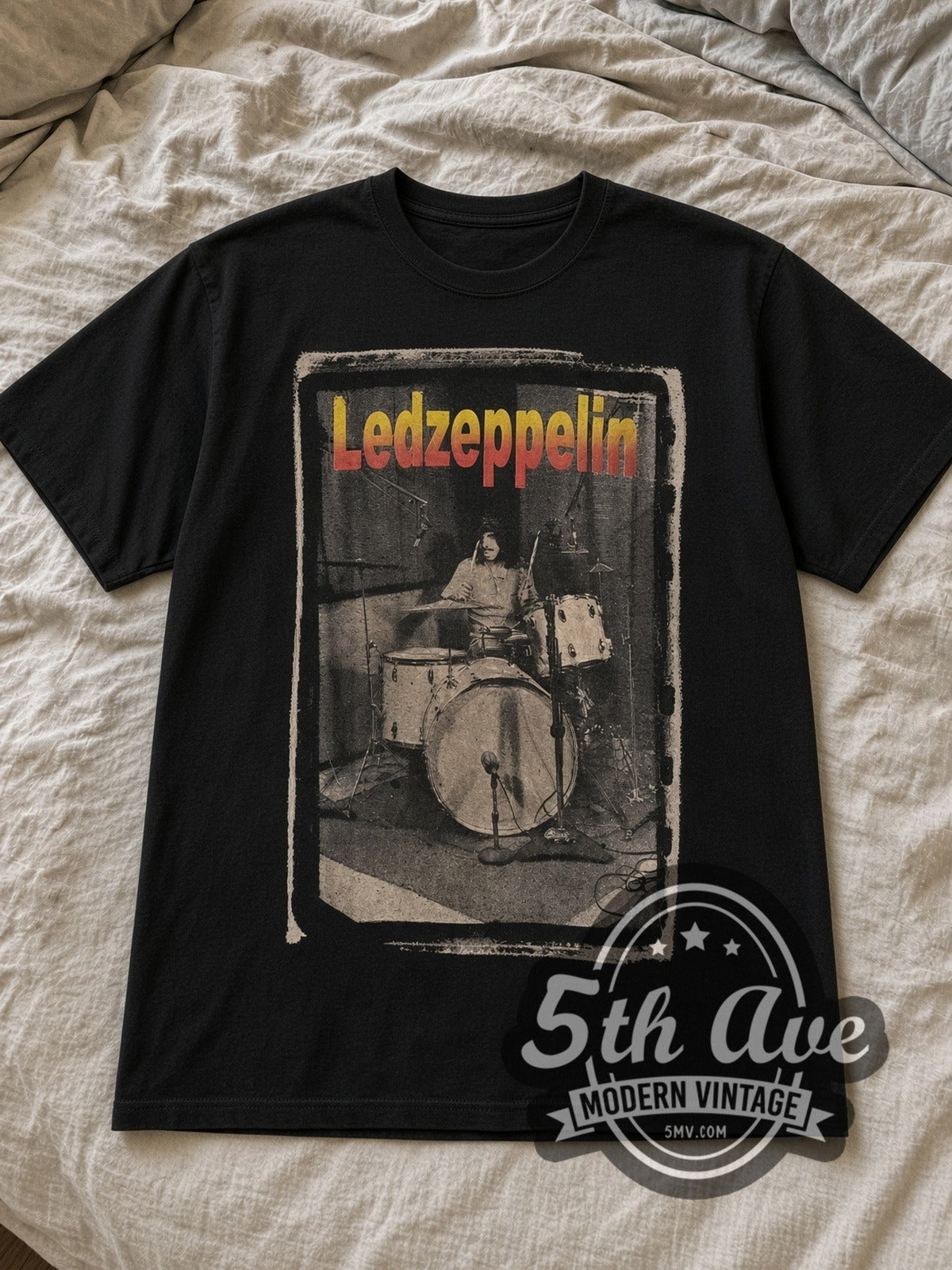 Black Led Zeppelin Drummer Tribute Vintage Band T-Shirt laid flat on a linen bed