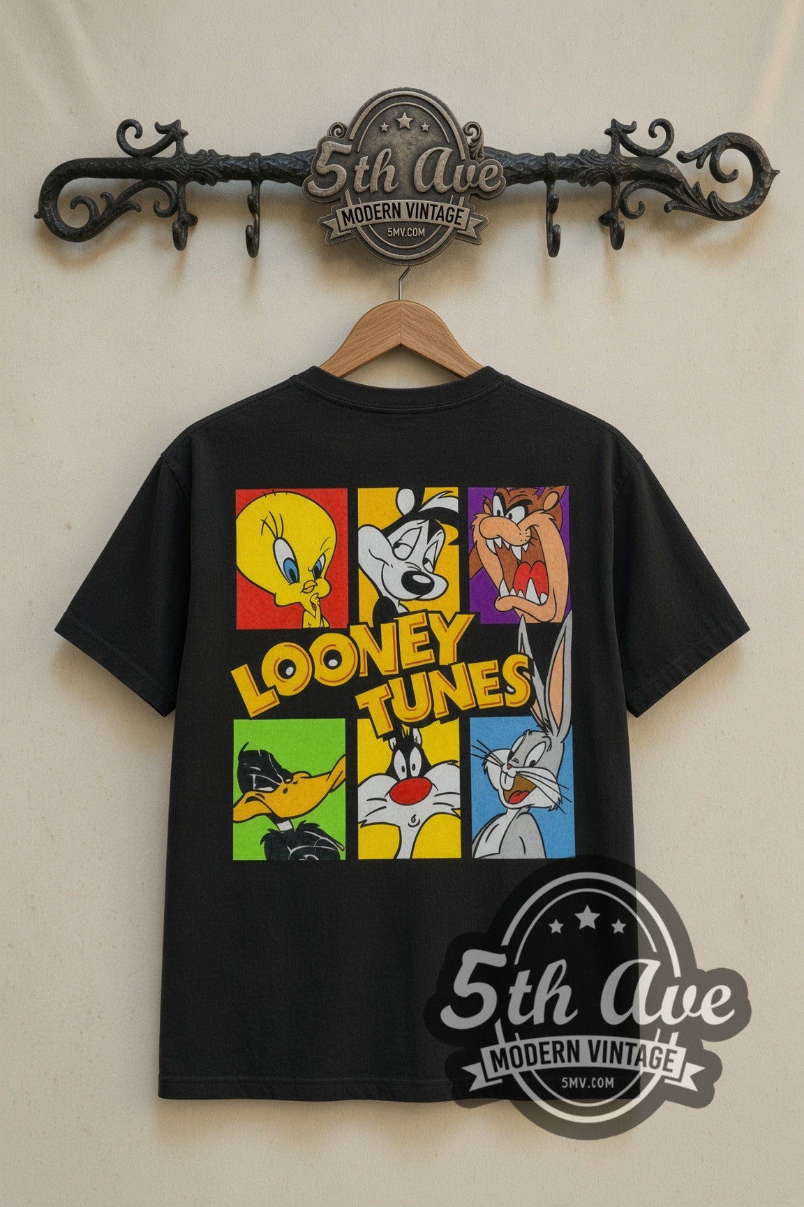 Looney Tunes 33 USA Stamp Tweety Sylvester cartoon tee in black, back view on a display rack