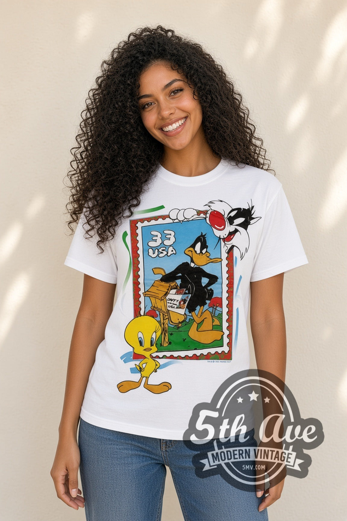 Model wearing the Looney Tunes 33 USA Stamp Tweety Sylvester cartoon tee in white