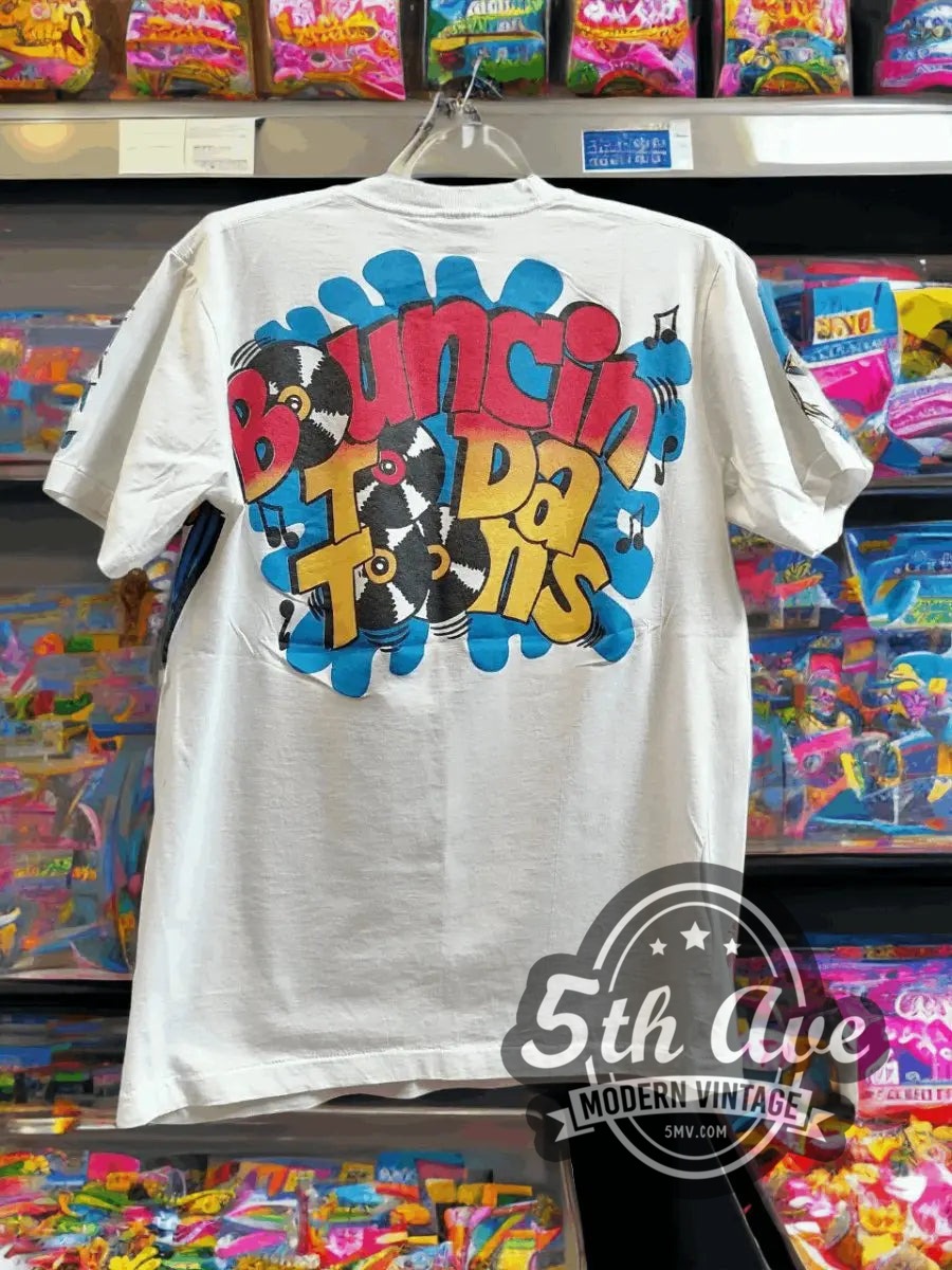Looney Tunes – All Over Print vintage cartoon t-shirt hanging on a hanger