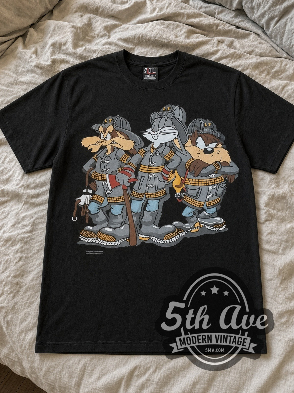 Looney Tunes Bugs Taz Ralph Wolf Firefighters cartoon tee in black laid flat on a bed, front artwork