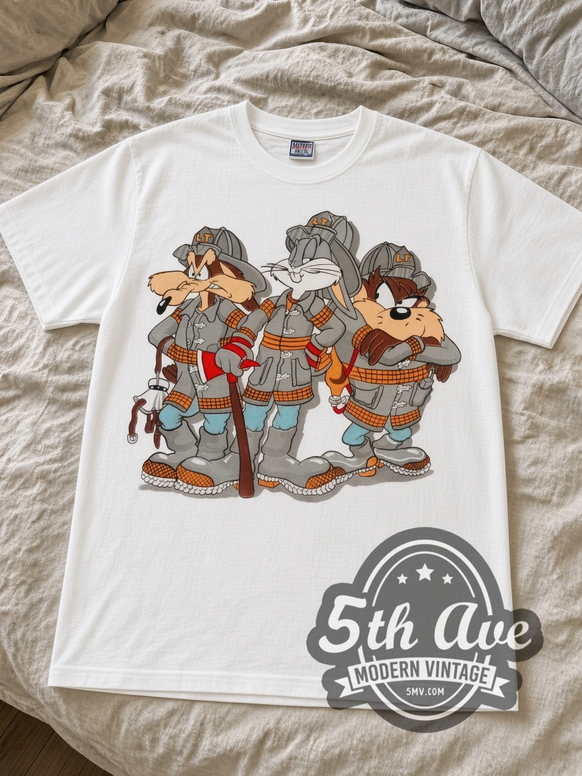 Looney Tunes Bugs Taz Ralph Wolf Firefighters cartoon tee in white laid flat on a bed, front artwork