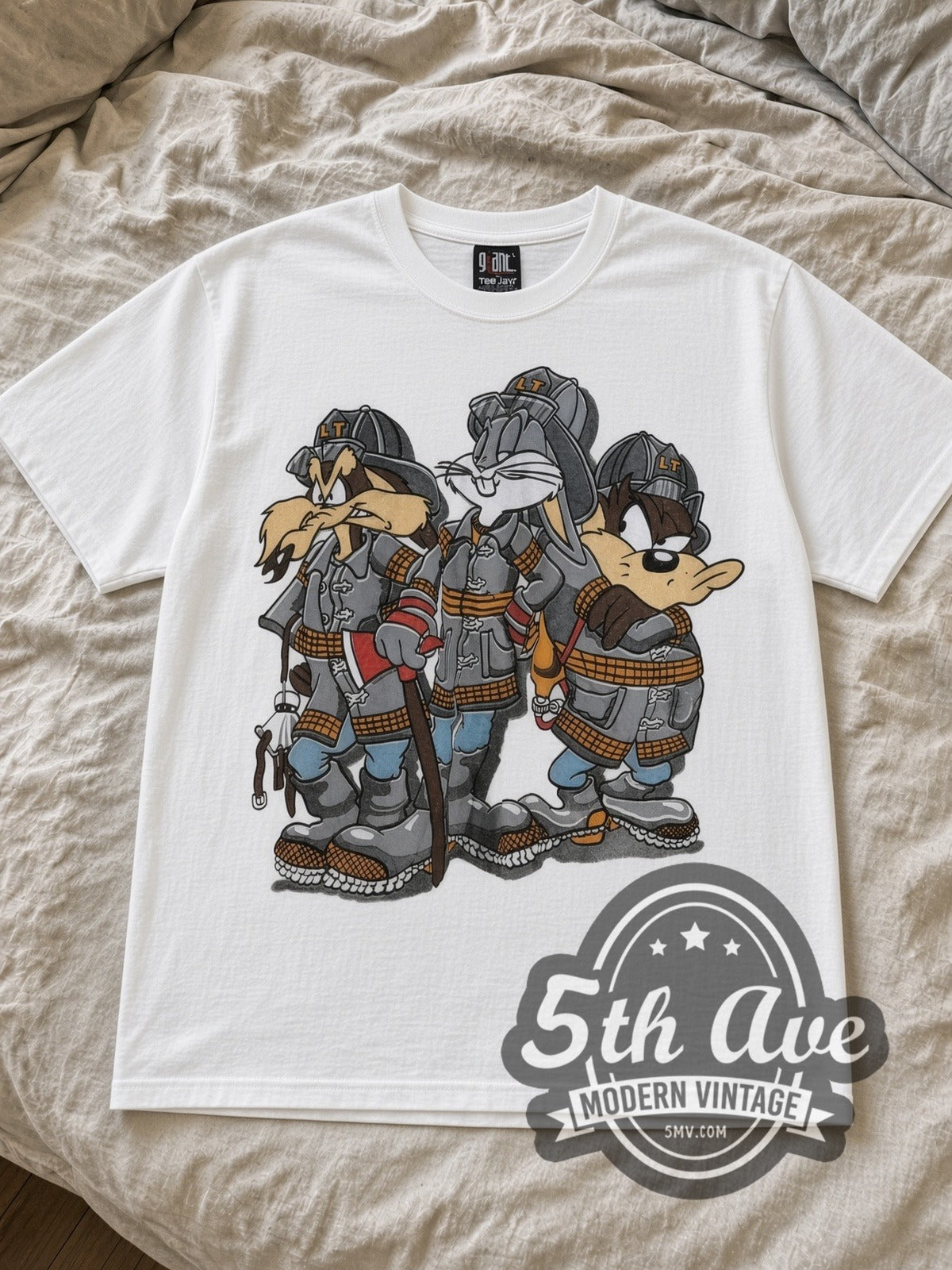 White Looney Tunes Bugs Bunny, Taz Mania and Ralph Wolf Vintage Cartoon T-Shirt laid flat on a linen bed