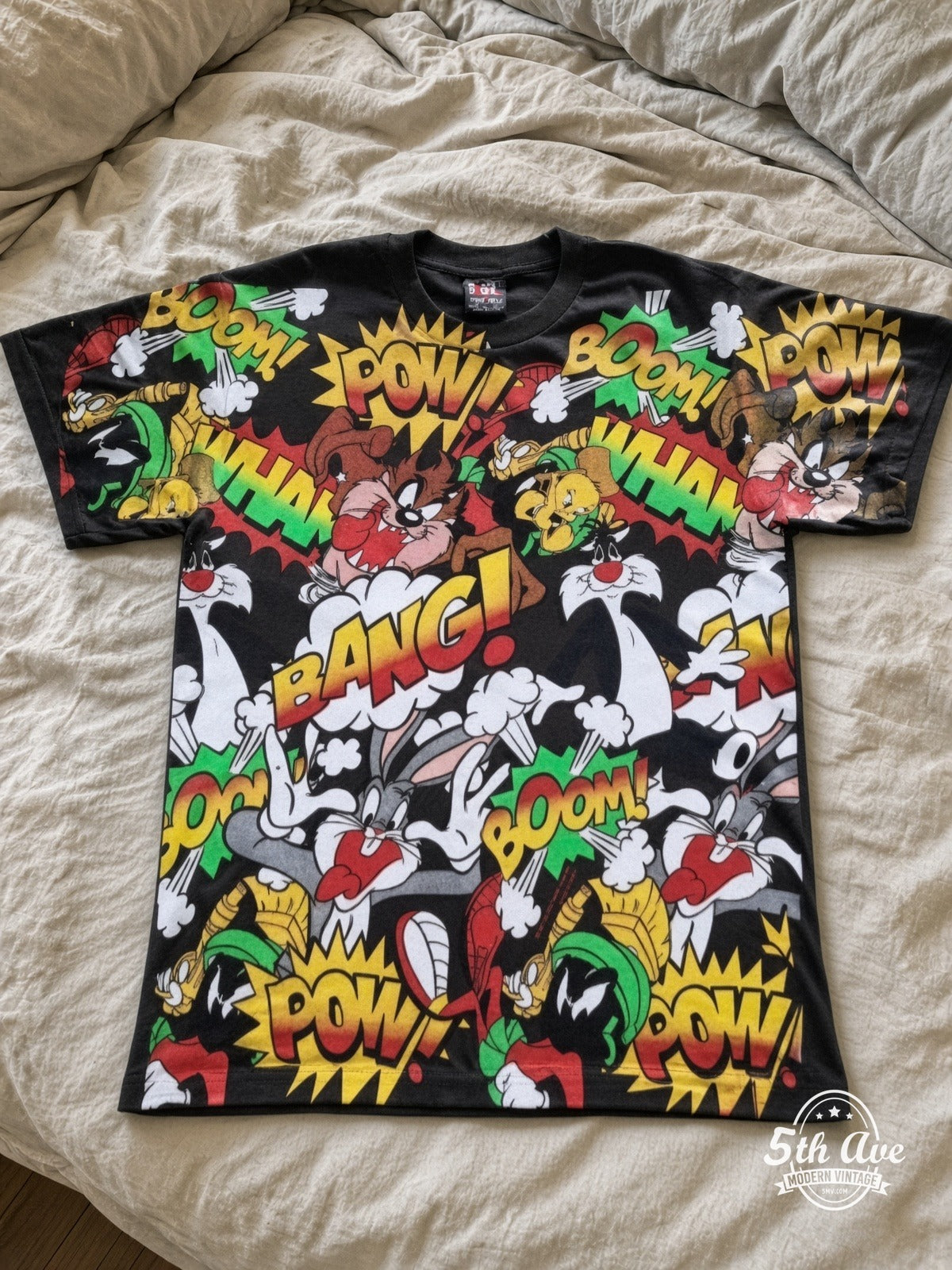 Looney Tunes Comic POW BANG Action Collage vintage tee laid on bed