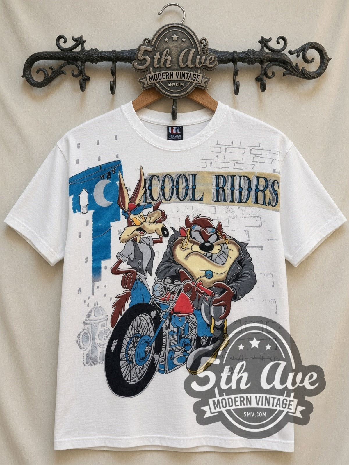 Looney Tunes Cool Riders Taz & Wile E all-over-print vintage cartoon t-shirt in white, front view on a display rack