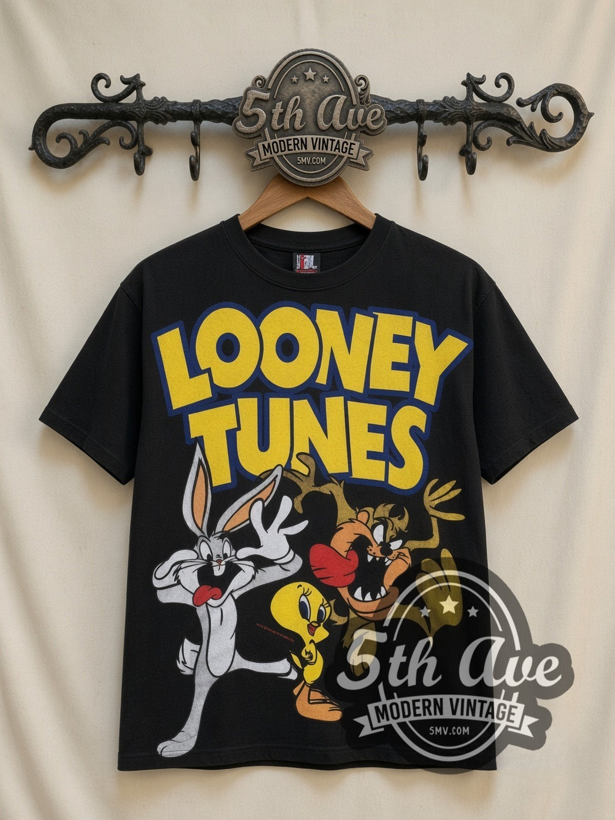 Looney Tunes Logo Bugs Tweety Taz Crew all-over-print vintage cartoon t-shirt in black, front view on a display rack