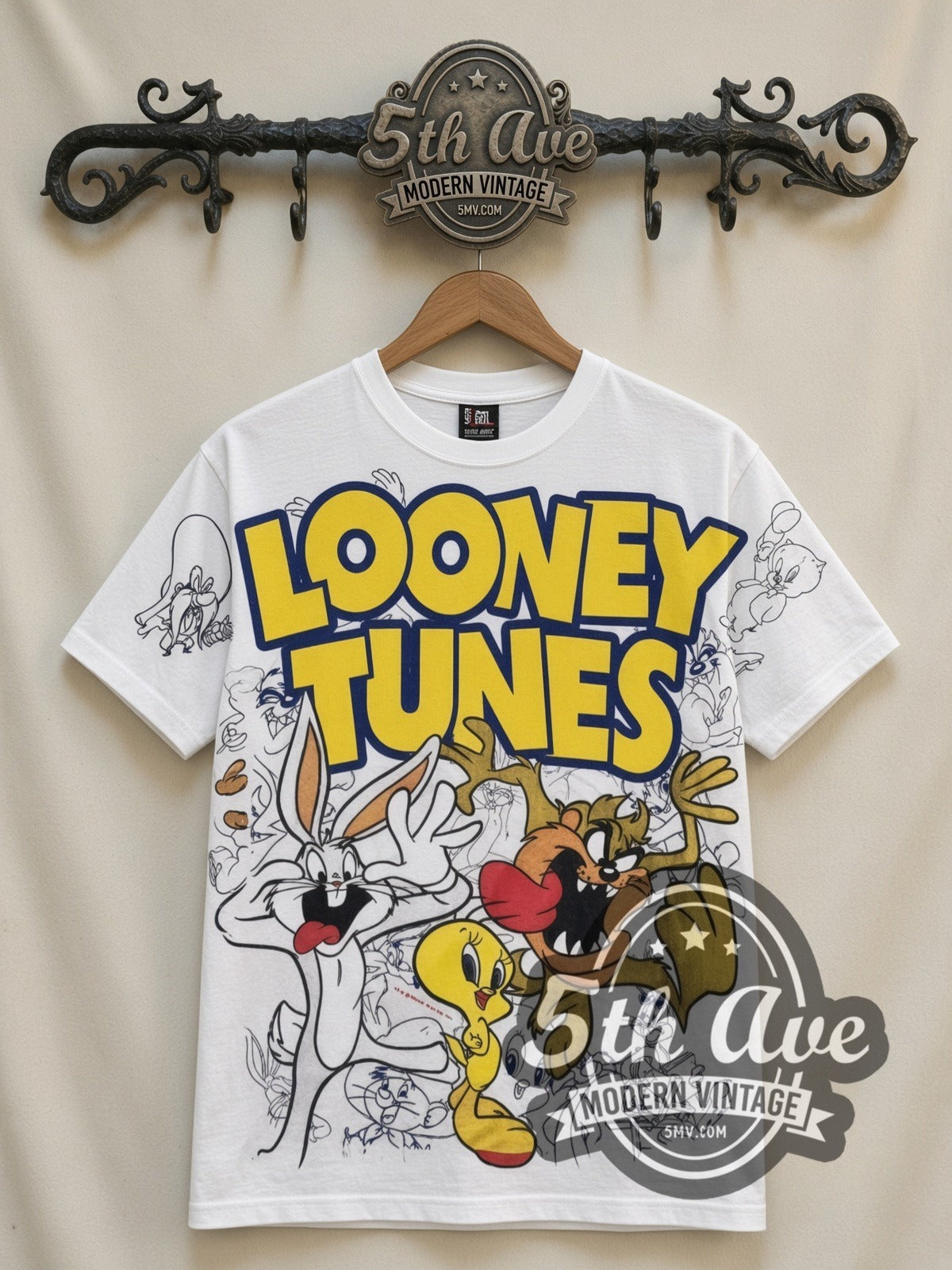 Looney Tunes Logo Bugs Tweety Taz Crew all-over-print vintage cartoon t-shirt in white, front view on a display rack