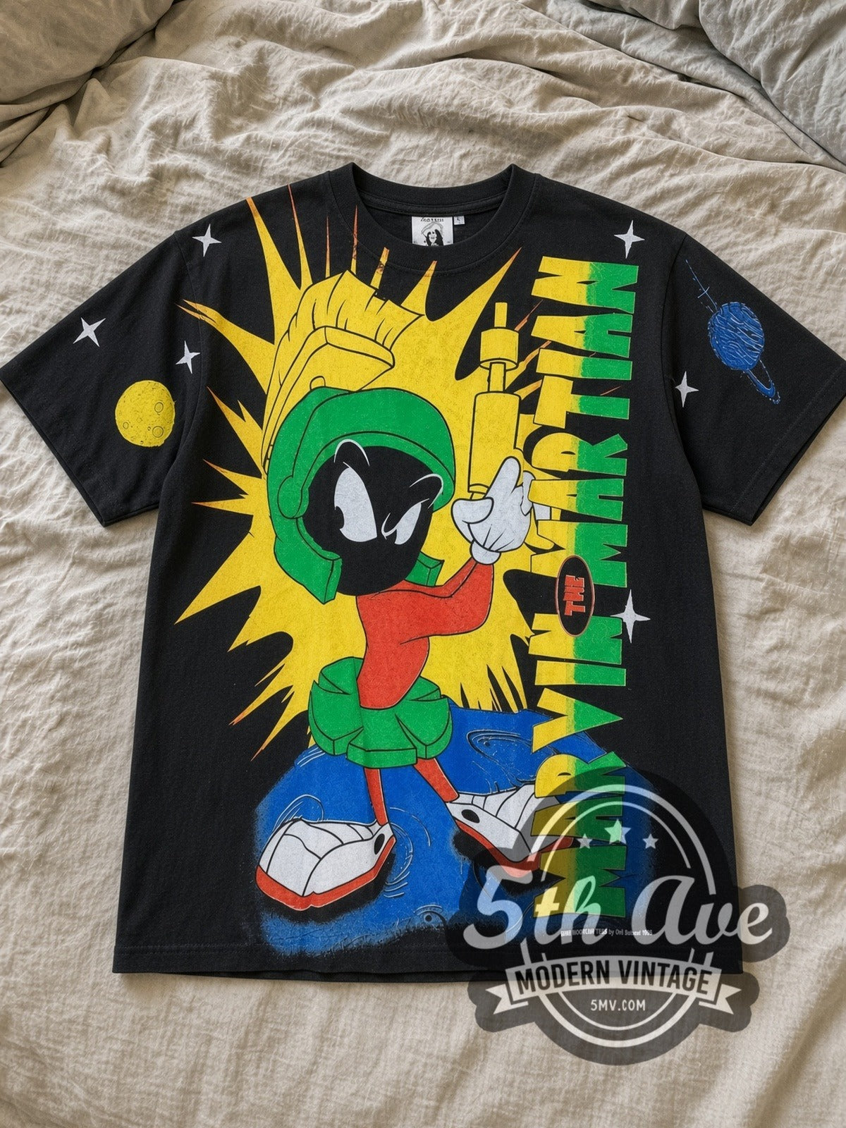 Black Looney Tunes Marvin the Martian All Over Print Vintage Cartoon T-Shirt laid flat on a linen bed
