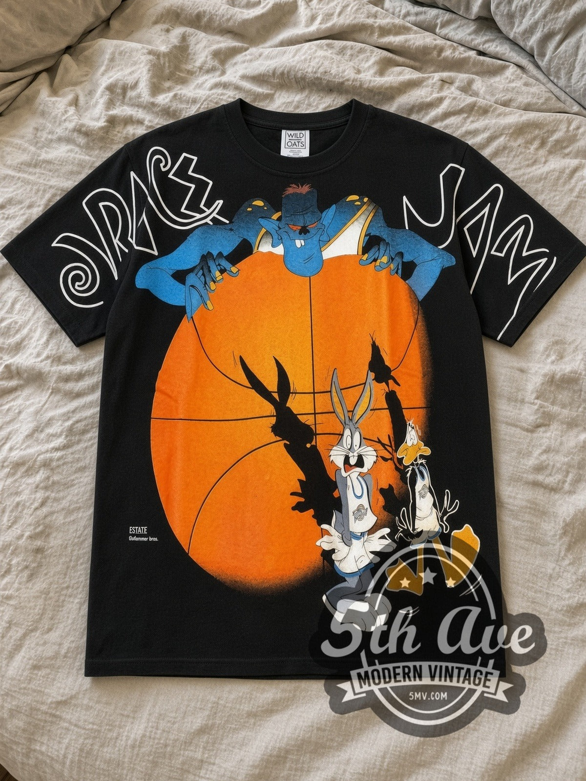 Black Looney Tunes Space Jam Bugs Bunny and Daffy Duck All Over Print Vintage Cartoon T-Shirt laid flat on a linen bed