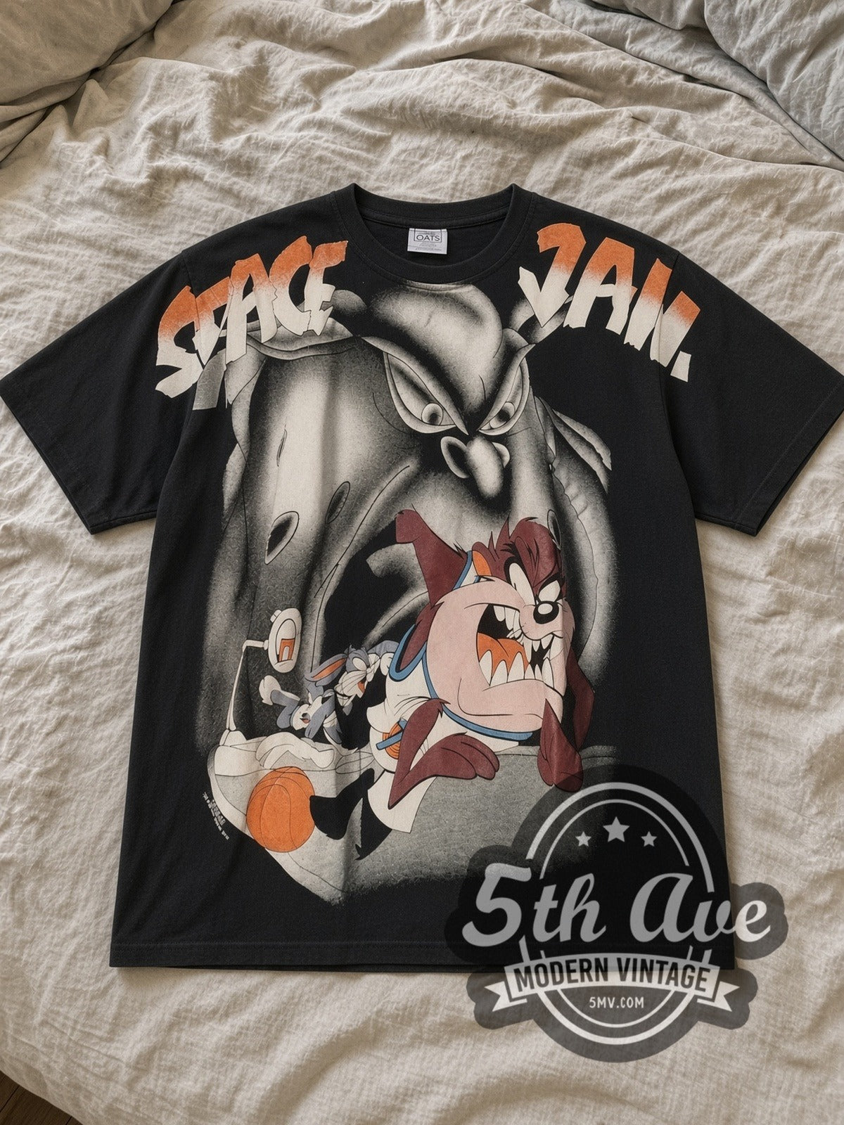 Black Looney Tunes Space Jam All Over Print Vintage Cartoon T-Shirt laid flat on a linen bed