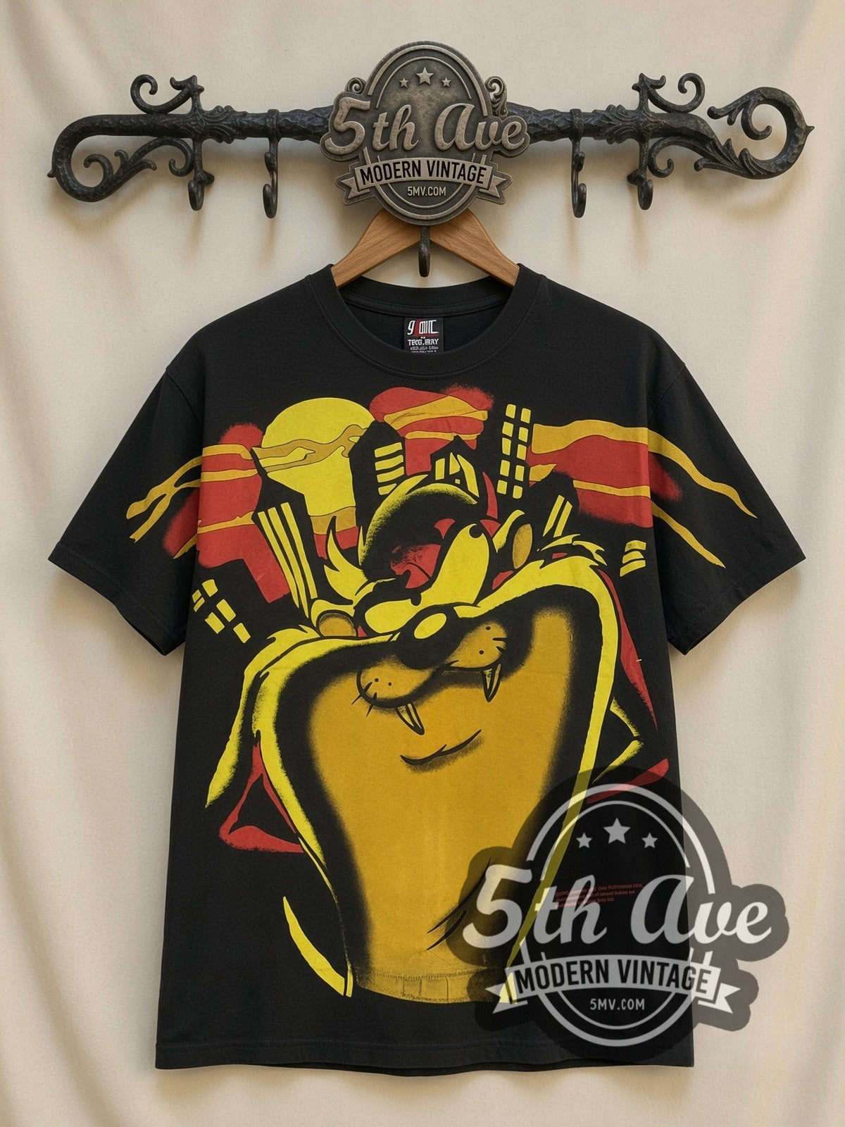 Looney Tunes Taz Giant Face Yellow all-over-print vintage cartoon t-shirt, front view on a display rack