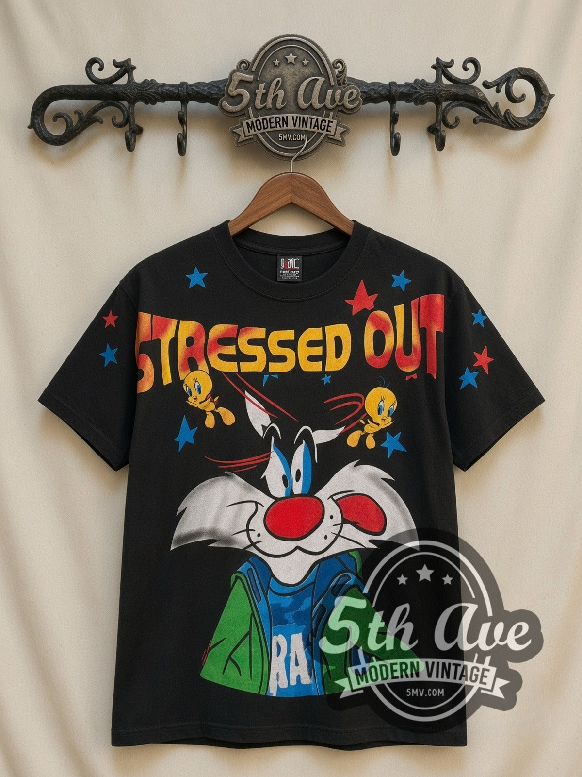 Looney Tunes Sylvester & Tweety Stressed Out all-over-print vintage cartoon t-shirt in black, front view on a display rack