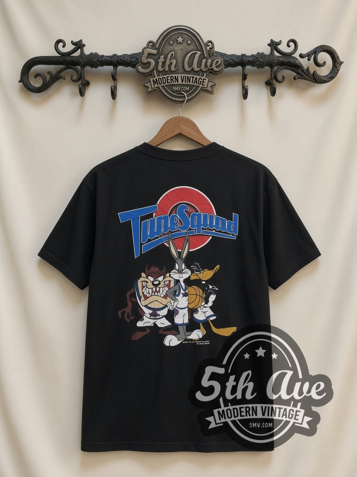 Looney Tunes Circle Badge Group all-over-print vintage cartoon t-shirt in black, back view on a display rack