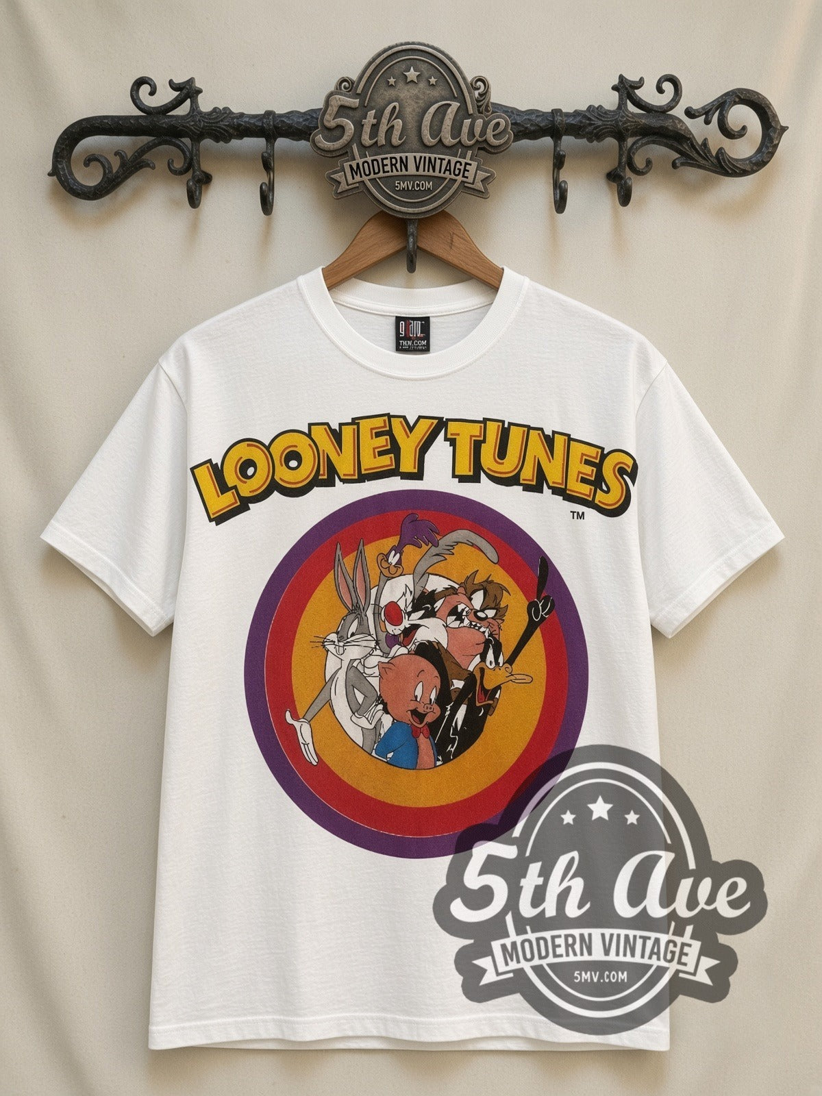 Looney Tunes Circle Badge Group all-over-print vintage cartoon t-shirt in white, front view on a display rack