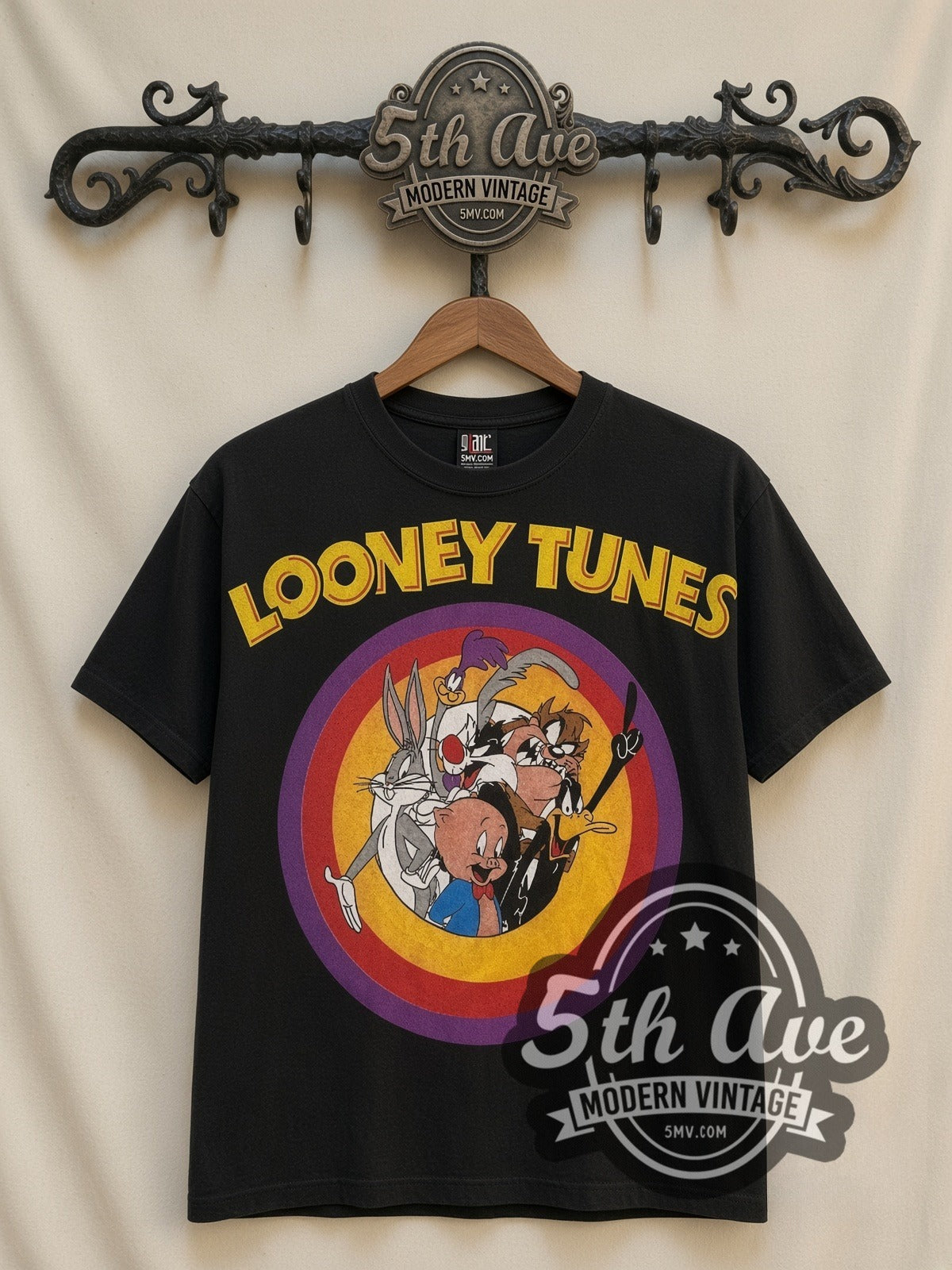 Looney Tunes Circle Badge Group all-over-print vintage cartoon t-shirt in black, front view on a display rack
