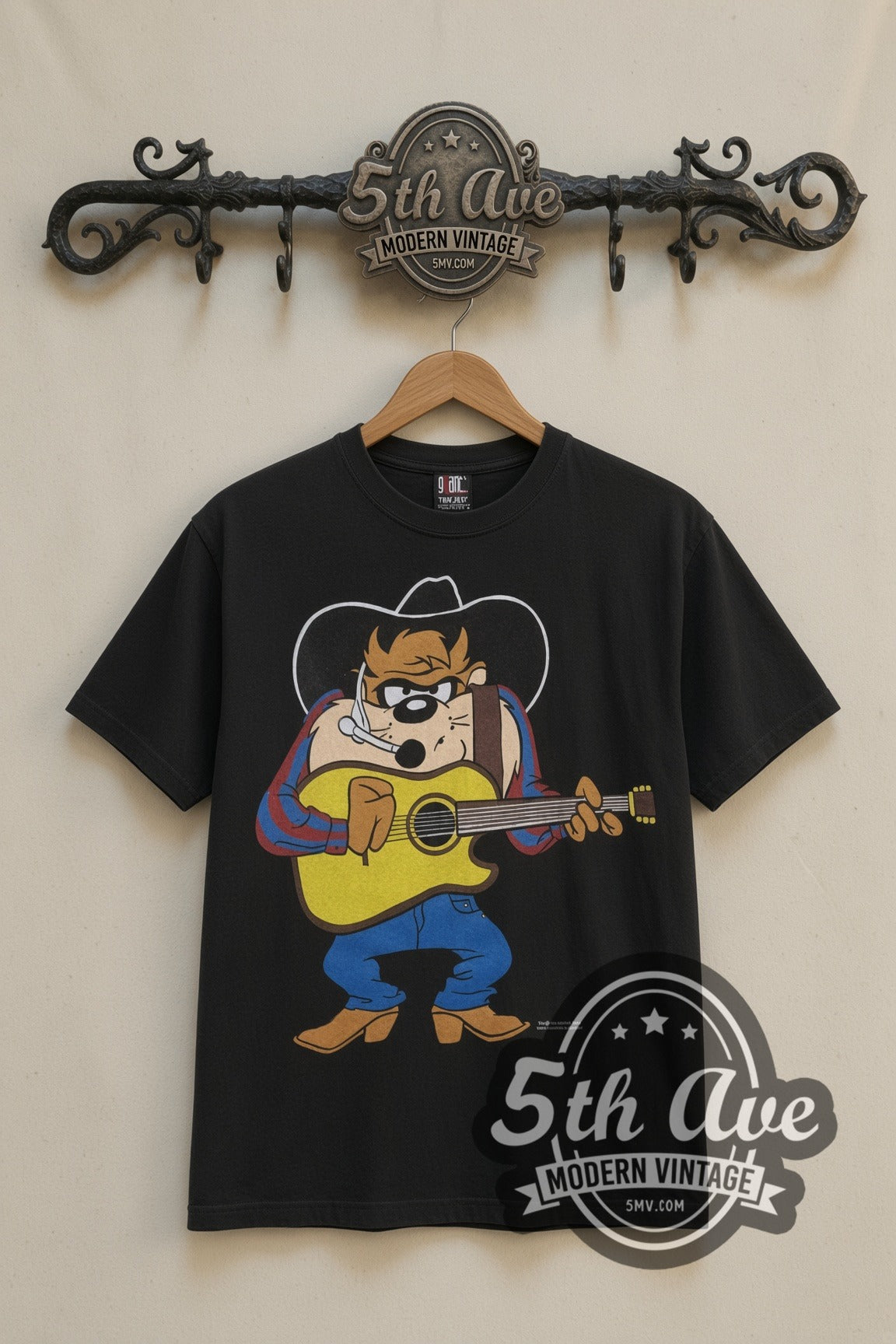 Looney Tunes Taz Cowboy Guitar Garth cartoon tee in black, front view on a display rack
