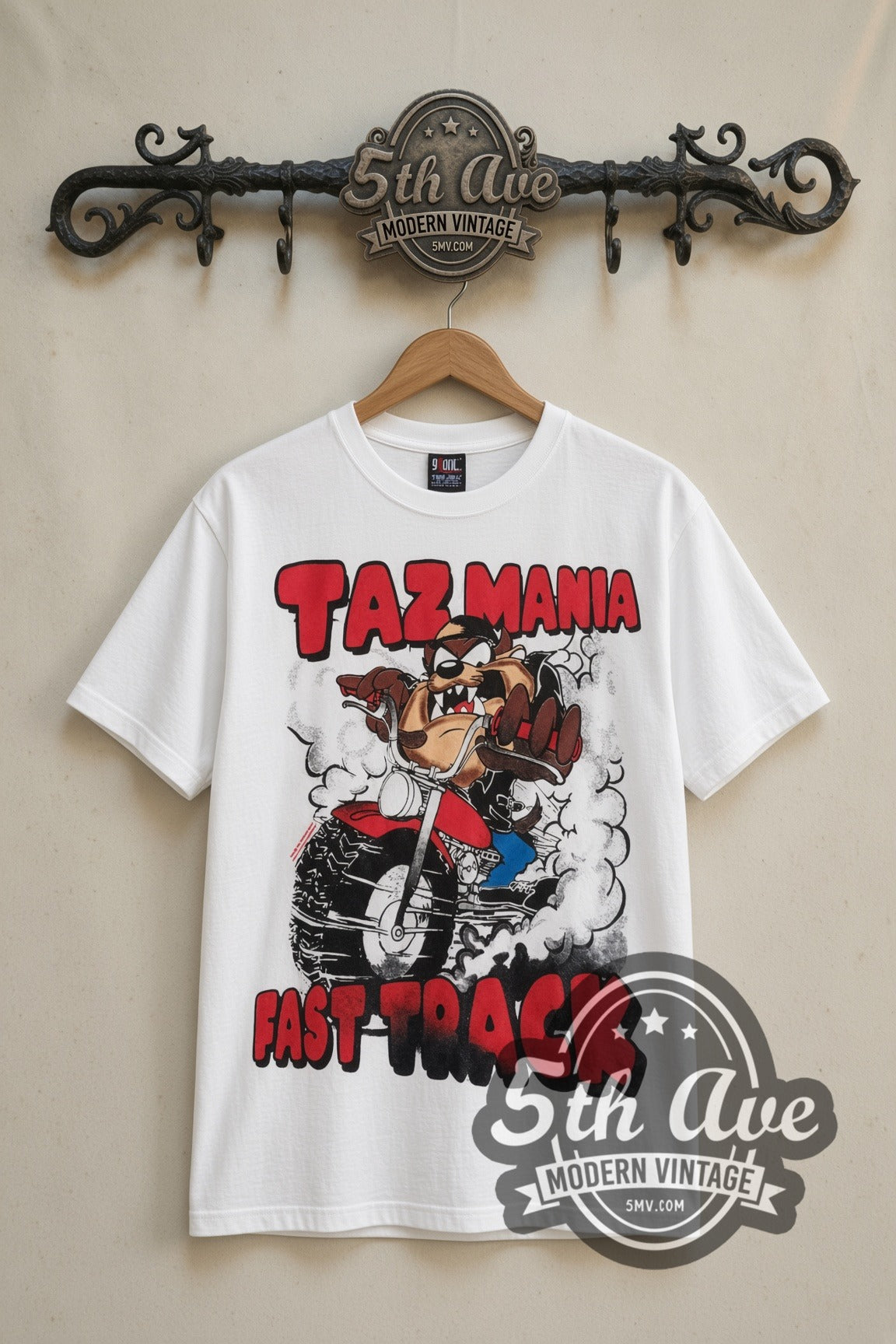 Looney Tunes Taz Fast Track cartoon tee in white, front view on a display rack