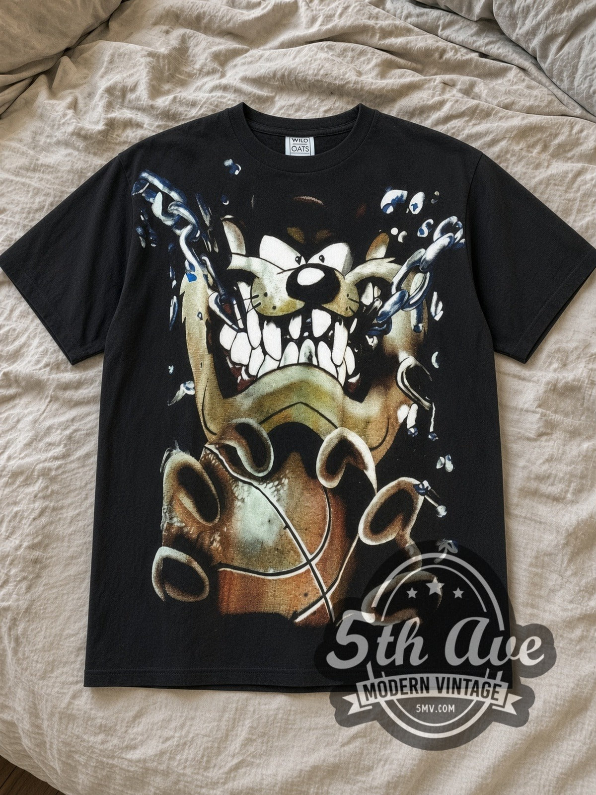 Black Looney Tunes Taz Mania Taz Tunes All Over Print Vintage Cartoon T-Shirt laid flat on a linen bed