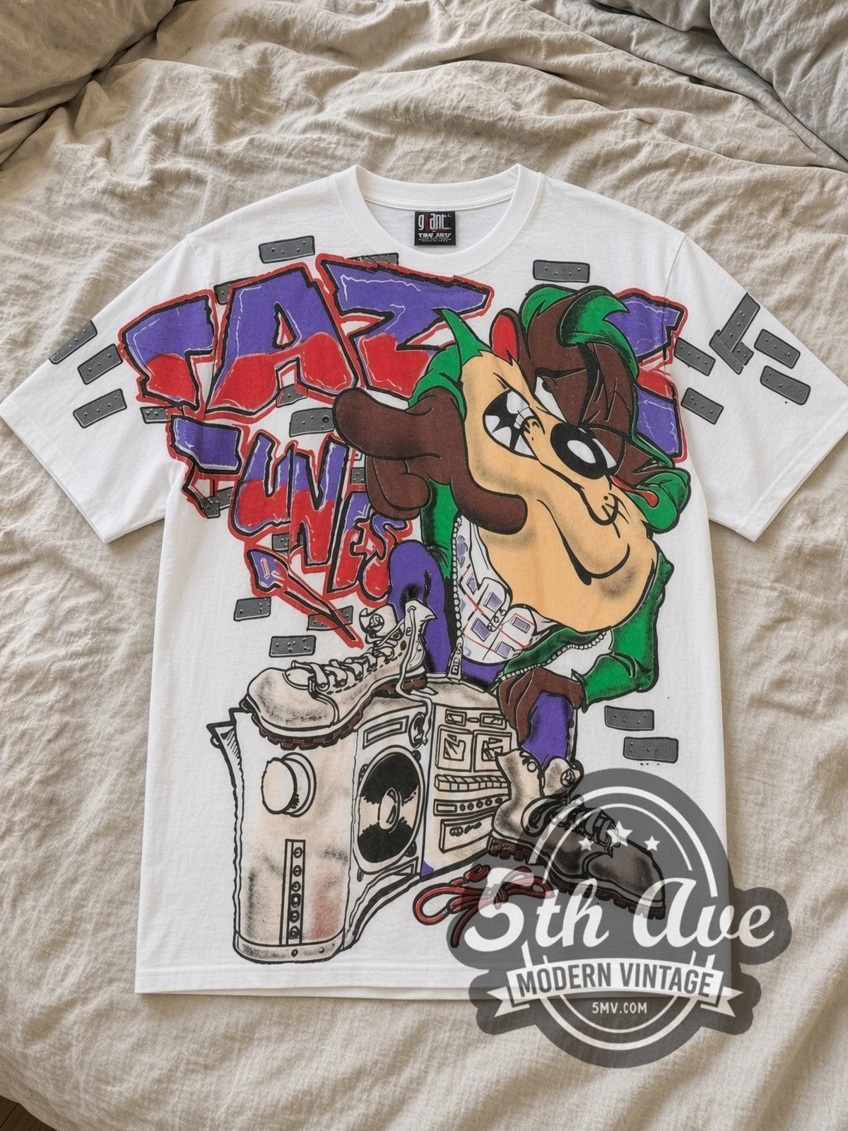 White Looney Tunes Taz Mania Classic Look All Over Print Vintage Cartoon T-Shirt laid flat on a linen bed
