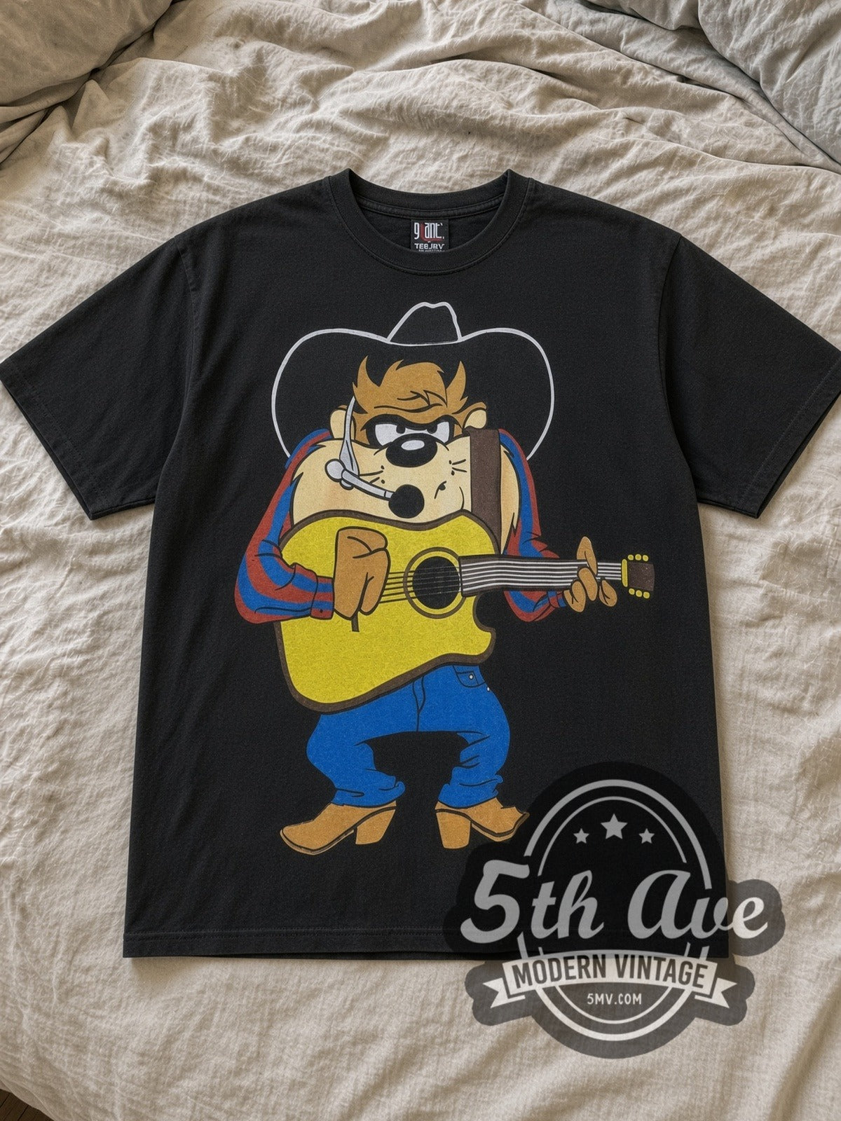 Black Looney Tunes Taz Mania All Over Print Vintage Cartoon T-Shirt laid flat on a linen bed
