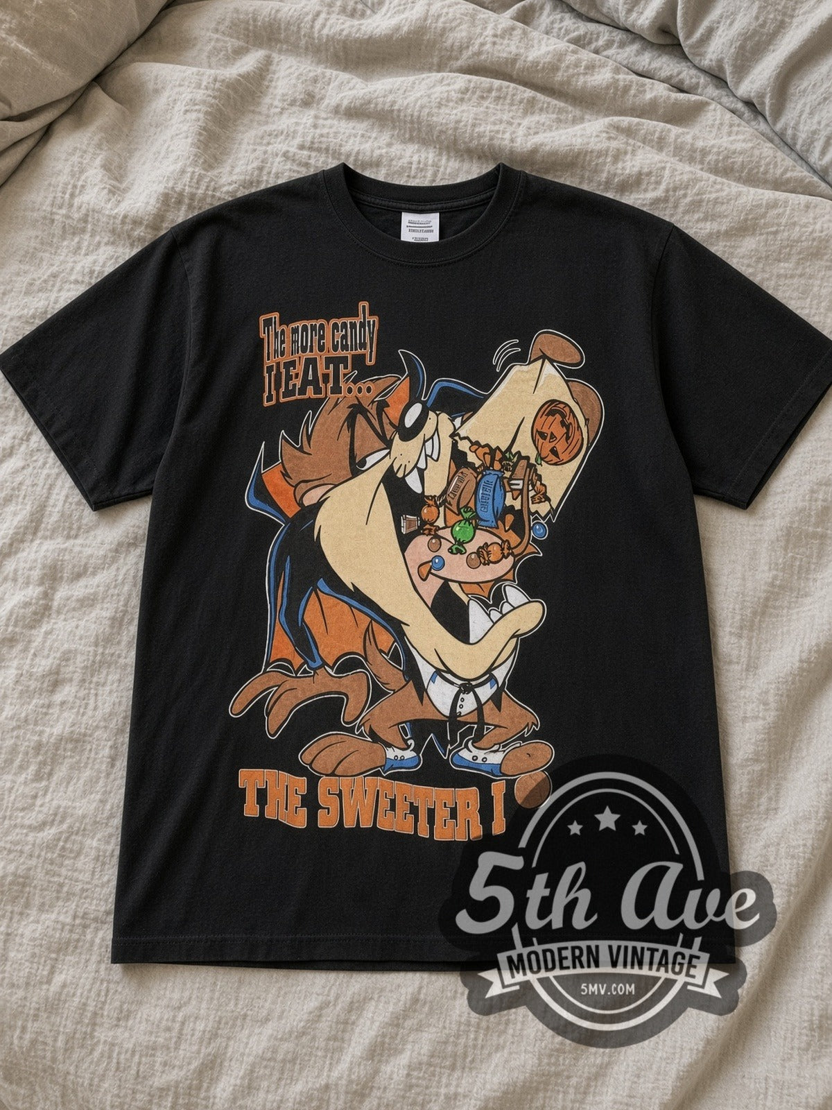 Black Looney Tunes Taz Mania The More Candy I Eat Vintage Cartoon T-Shirt laid flat on a linen bed