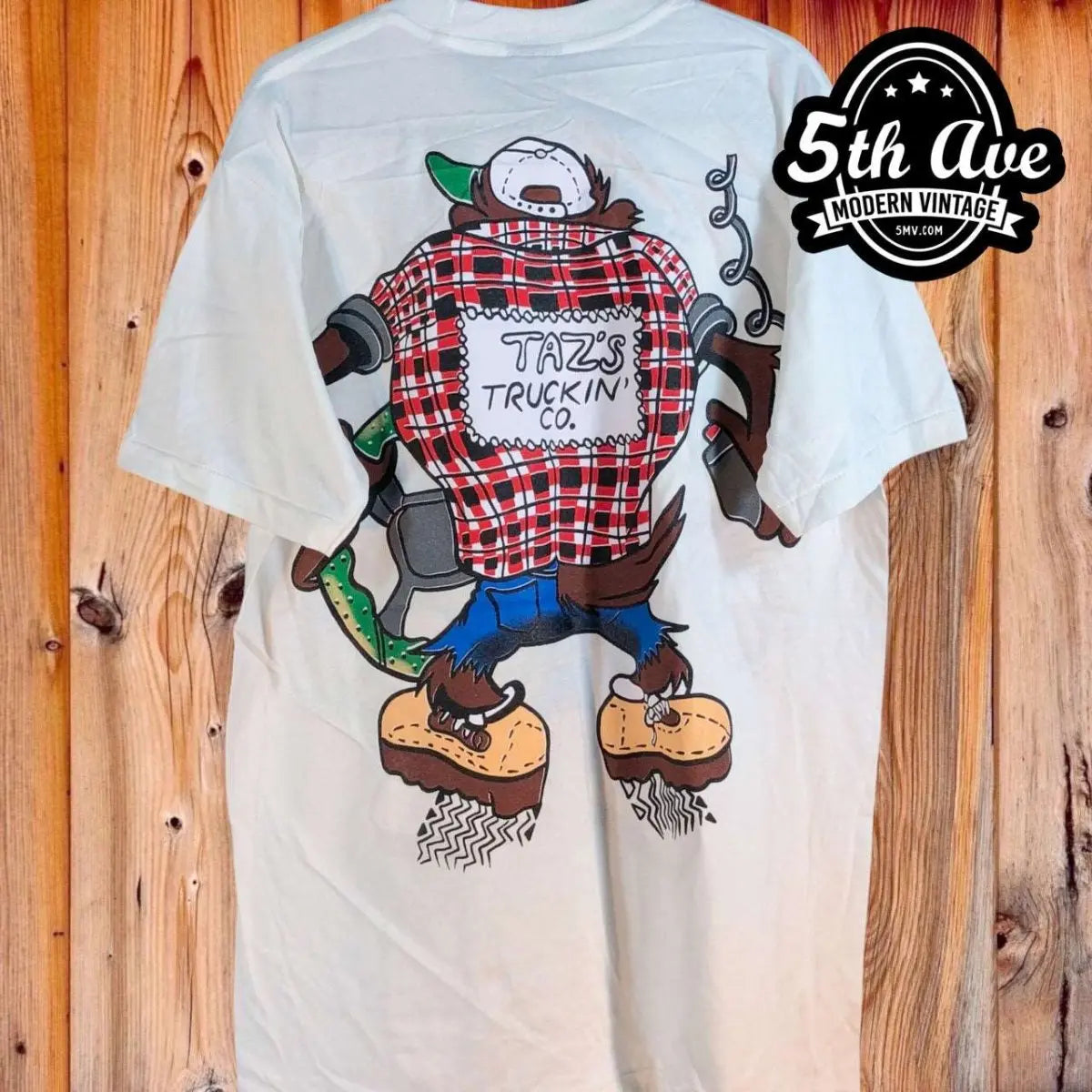 Looney Tunes – Taz Truckin Company – New Vintage Graphic Tee vintage t-shirt laid on bed