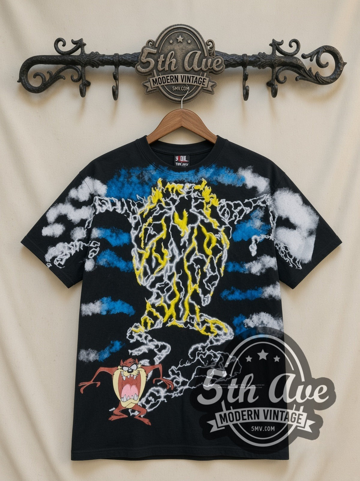 Looney Tunes Taz Tornado Lightning all-over-print vintage cartoon t-shirt, front view on a display rack