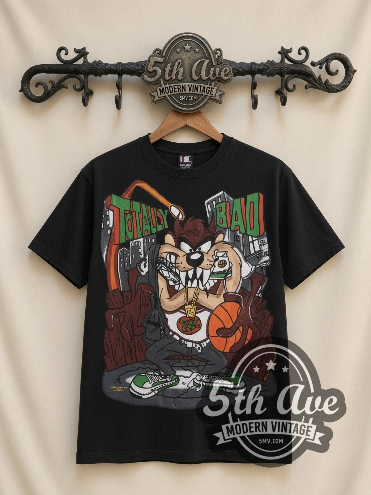 Looney Tunes Taz Totally Bad all-over-print vintage cartoon t-shirt in black, front view on a display rack