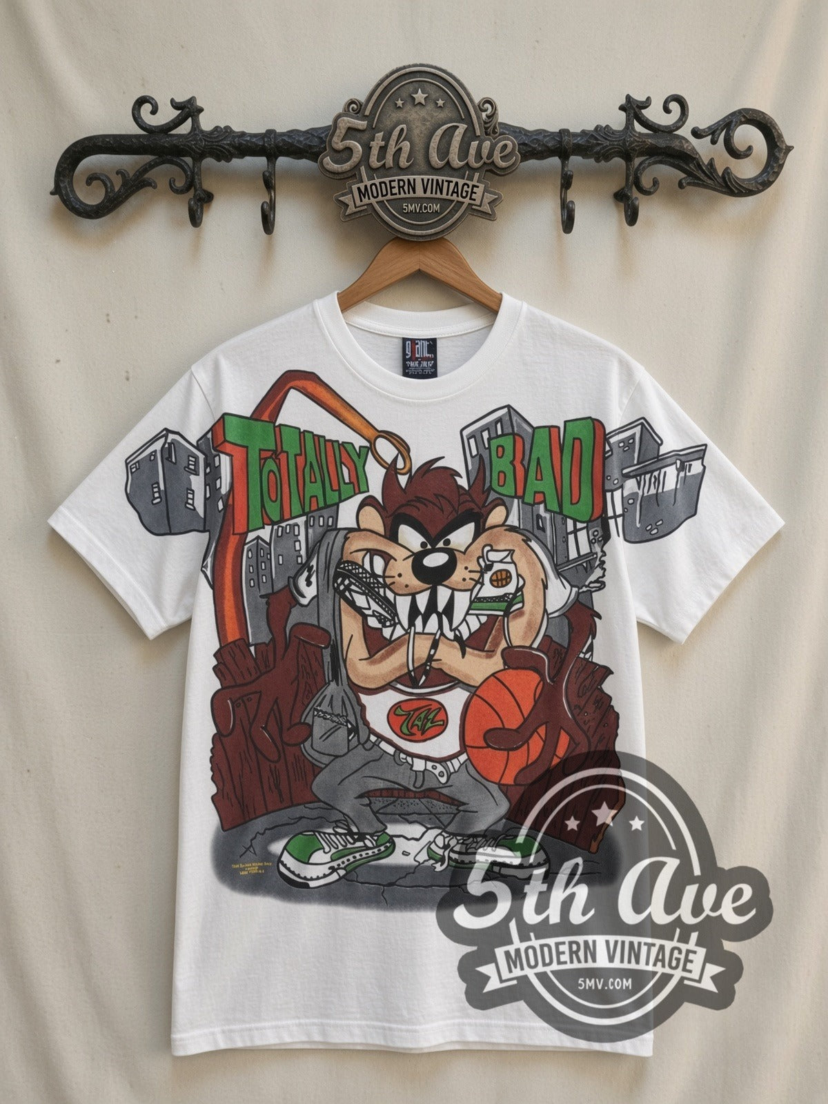 Looney Tunes Taz Totally Bad all-over-print vintage cartoon t-shirt in white, front view on a display rack