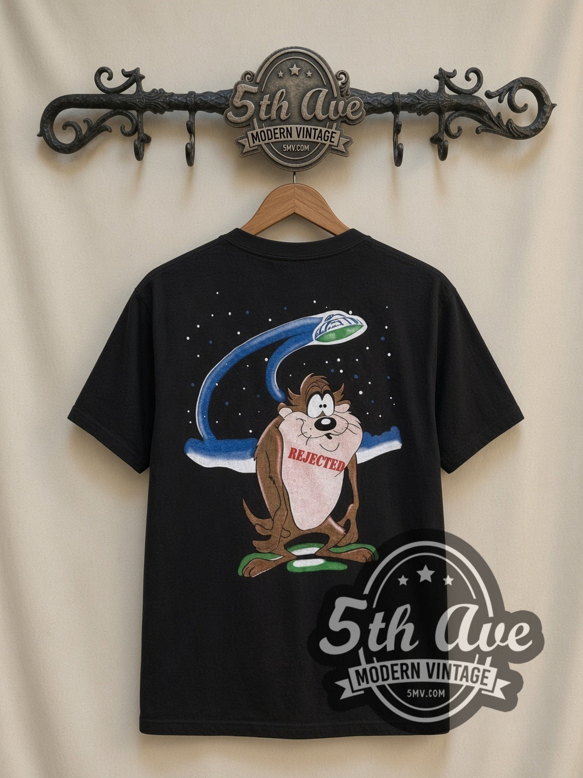 Looney Tunes Taz UFO Abduction all-over-print vintage cartoon t-shirt in black, back view on a display rack