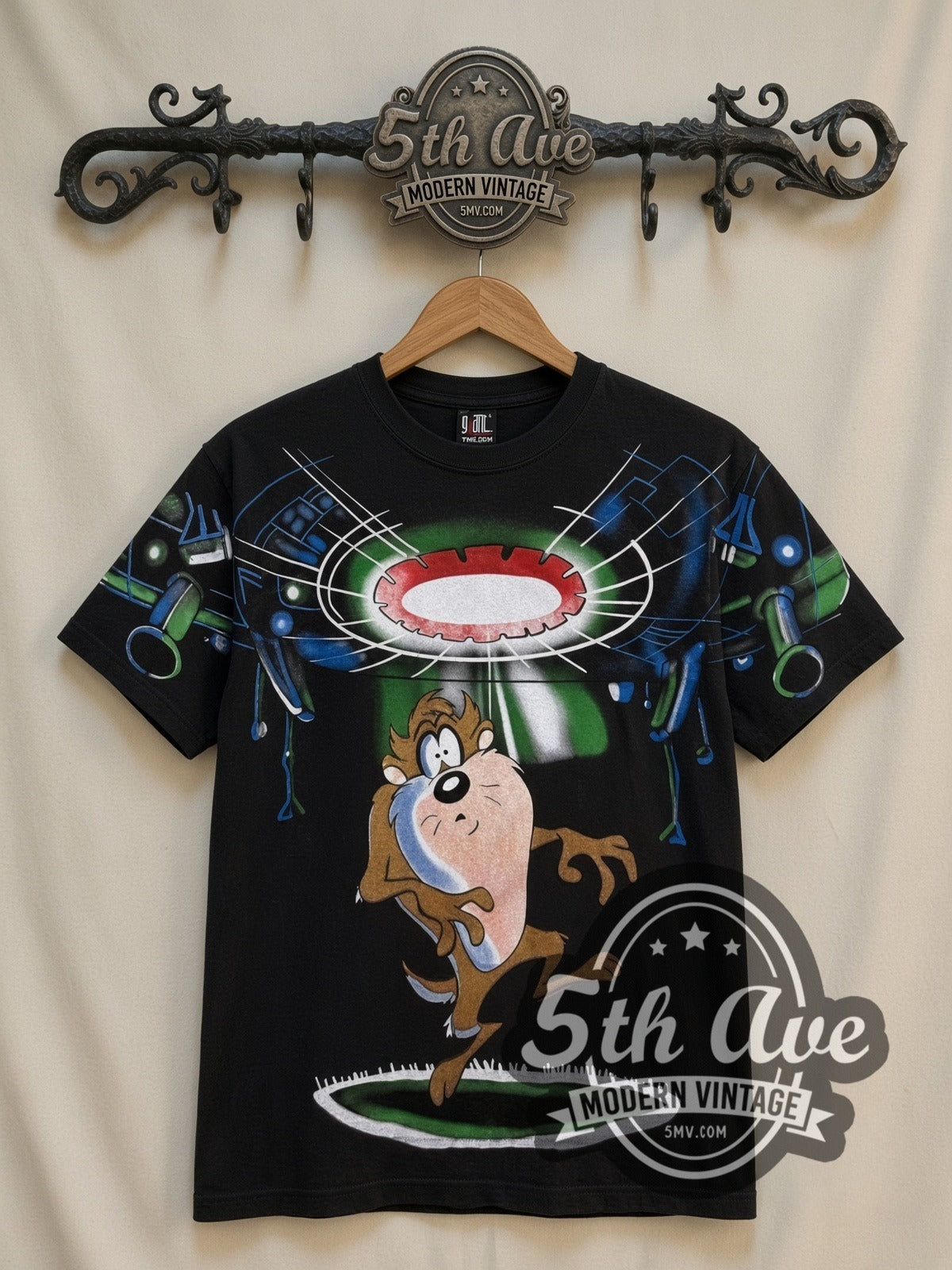 Looney Tunes Taz UFO Abduction all-over-print vintage cartoon t-shirt in black, front view on a display rack