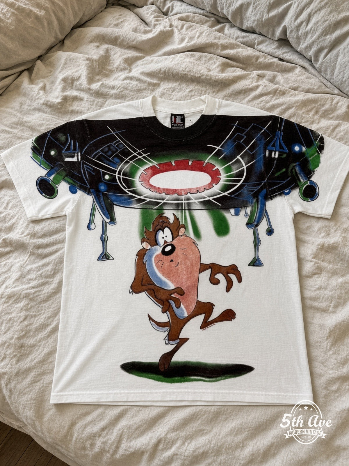 Looney Tunes Taz UFO Abduction vintage tee laid on bed
