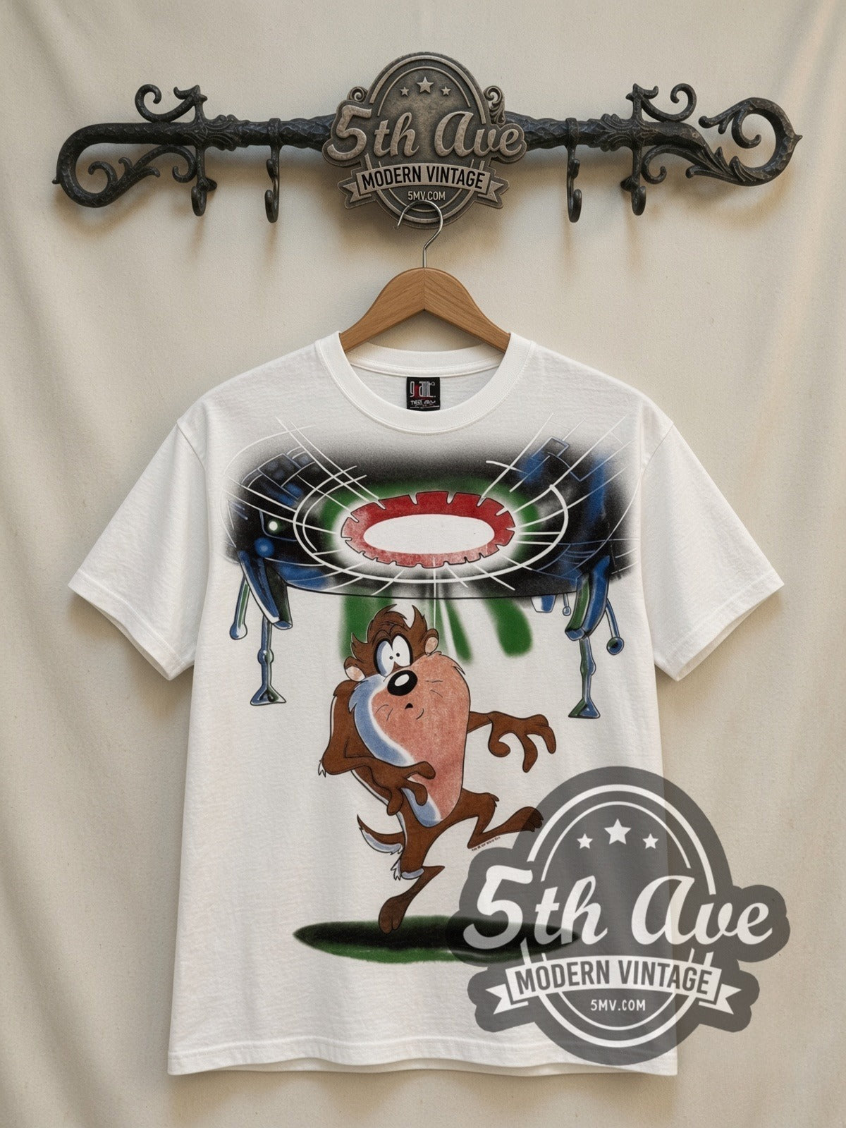 Looney Tunes Taz UFO Abduction all-over-print vintage cartoon t-shirt in white, front view on a display rack