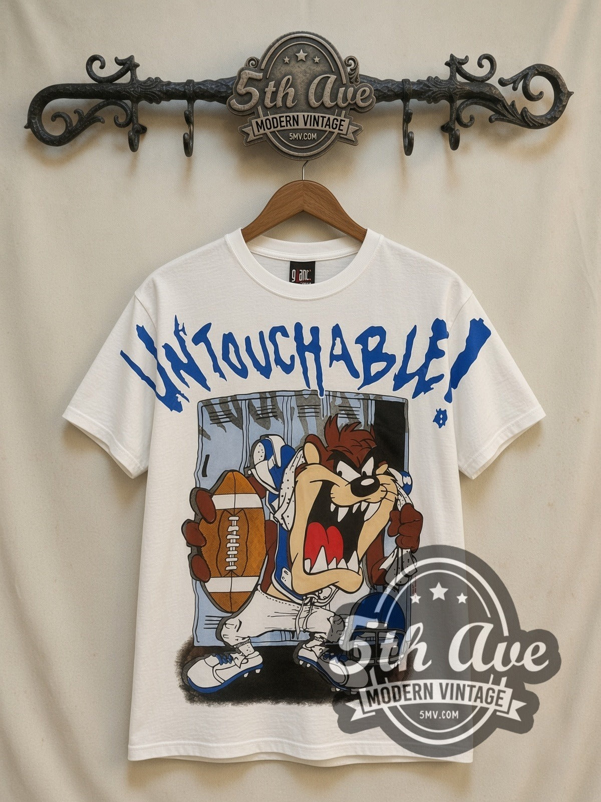Looney Tunes Taz Untouchable Football all-over-print vintage cartoon t-shirt in white, front view on a display rack