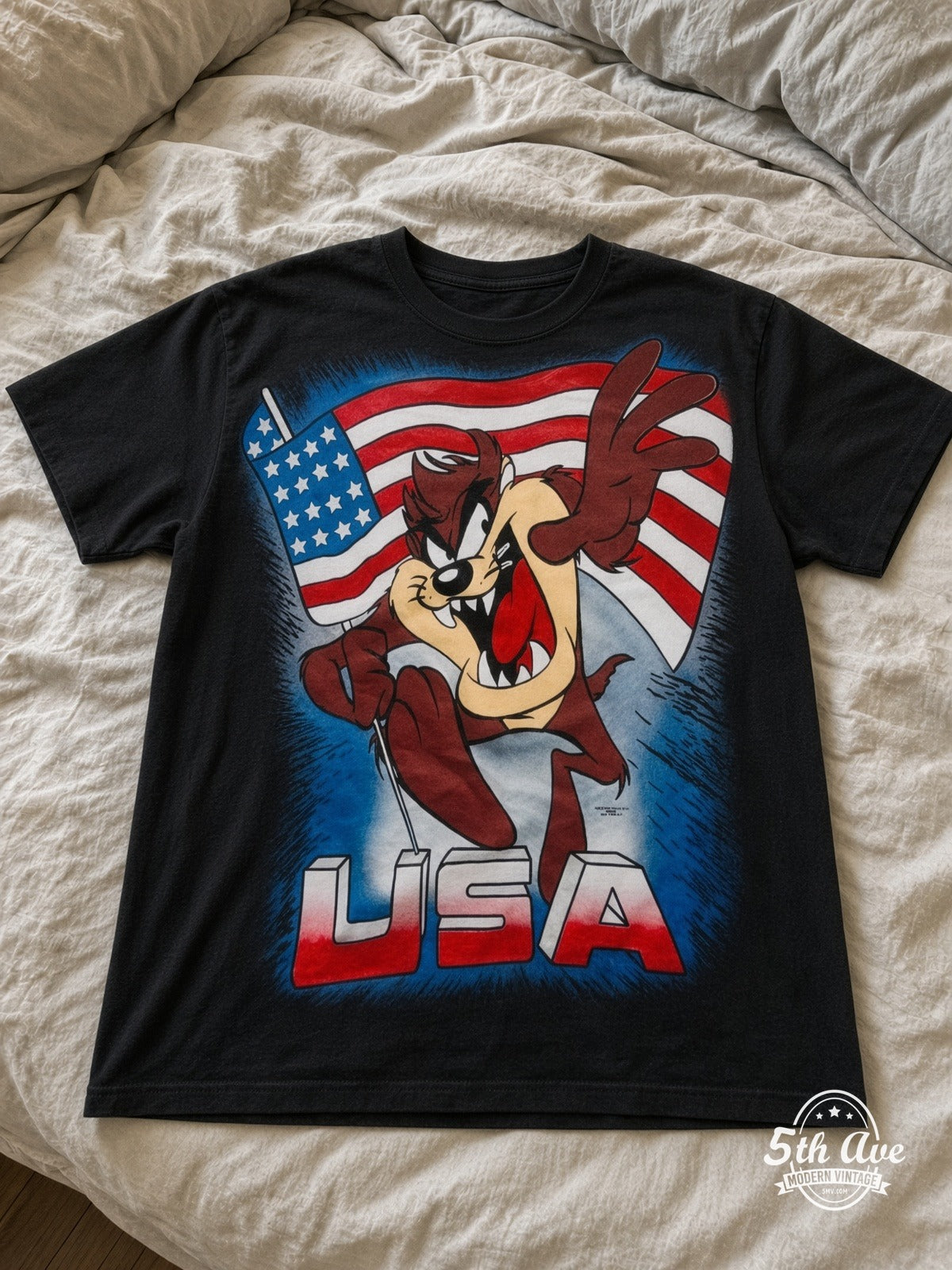 Looney Tunes Taz USA Flag vintage tee laid on bed