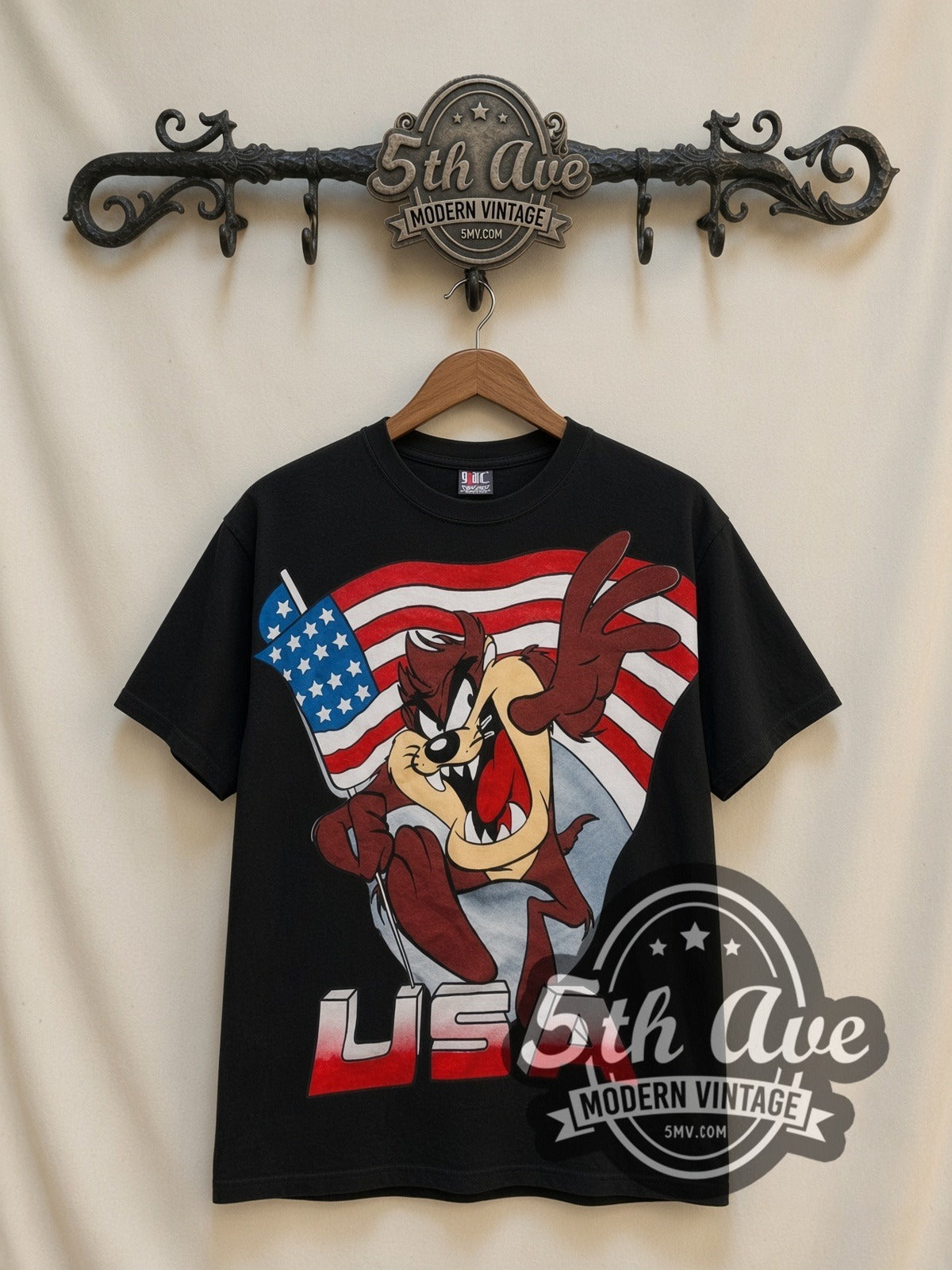 Looney Tunes Taz USA Flag all-over-print vintage cartoon t-shirt in black, front view on a display rack