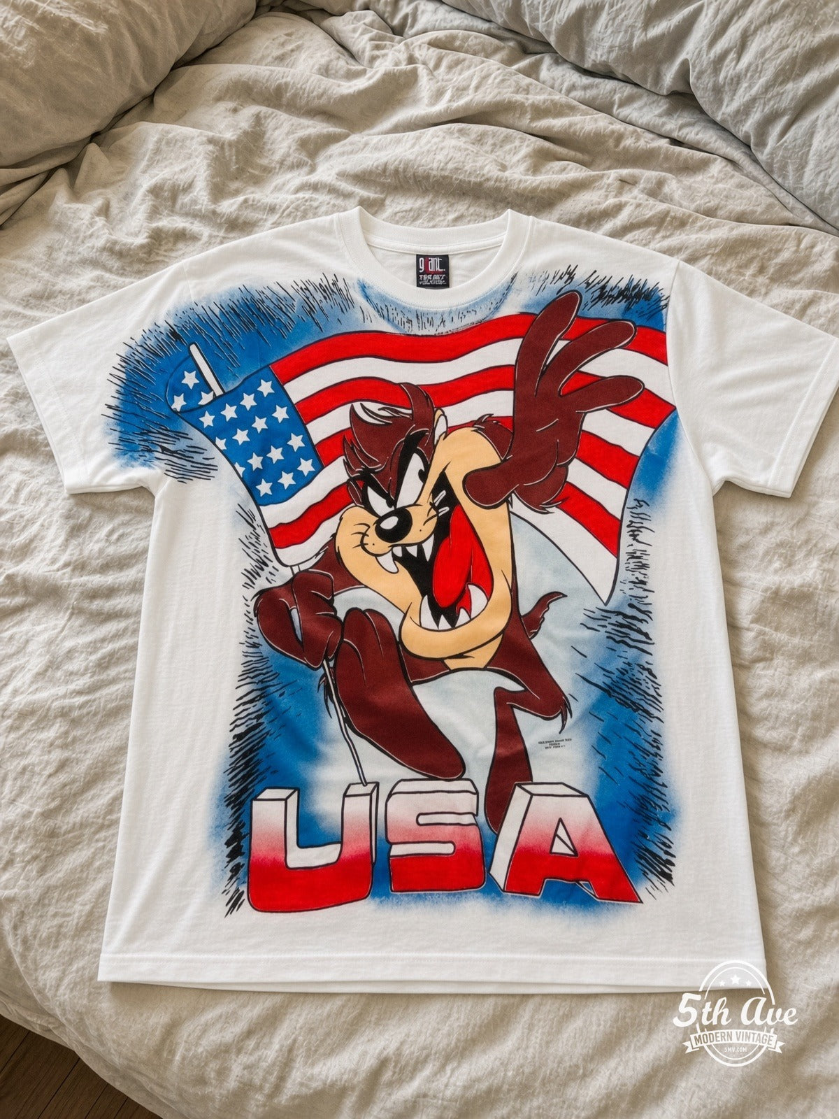 Looney Tunes Taz USA Flag vintage tee laid on bed