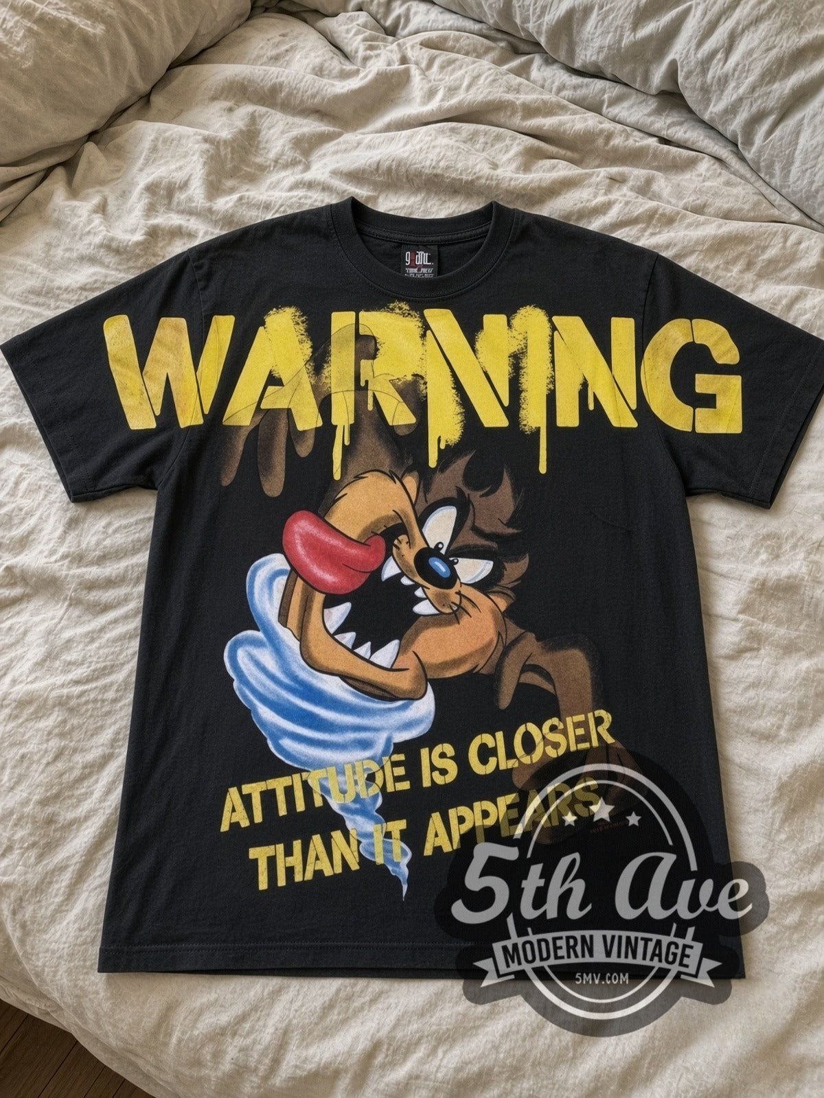 Looney Tunes Taz Warning Attitude Is Closer all-over-print vintage cartoon tee in black laid flat