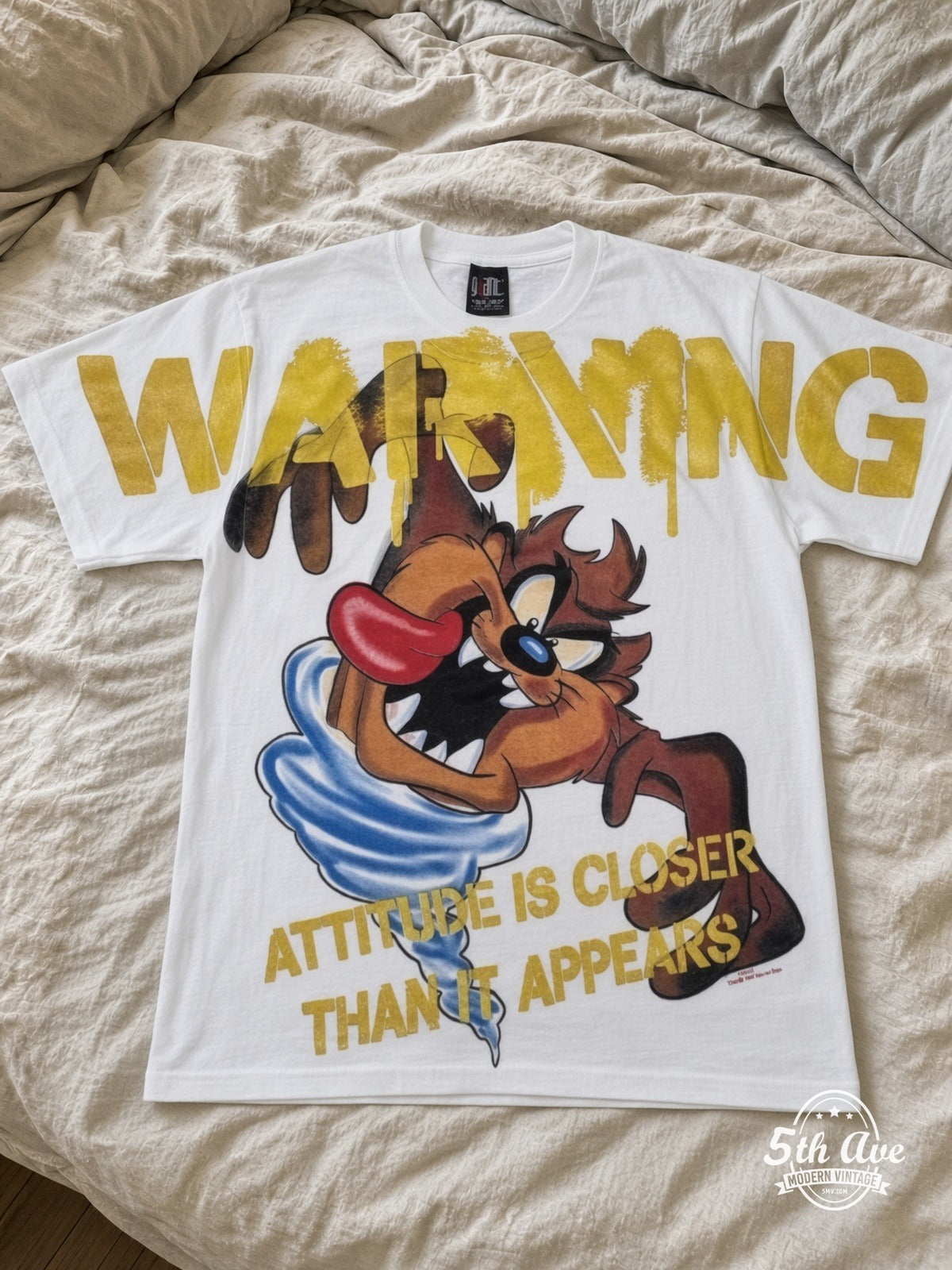 Looney Tunes Taz Warning Attitude vintage tee laid on bed