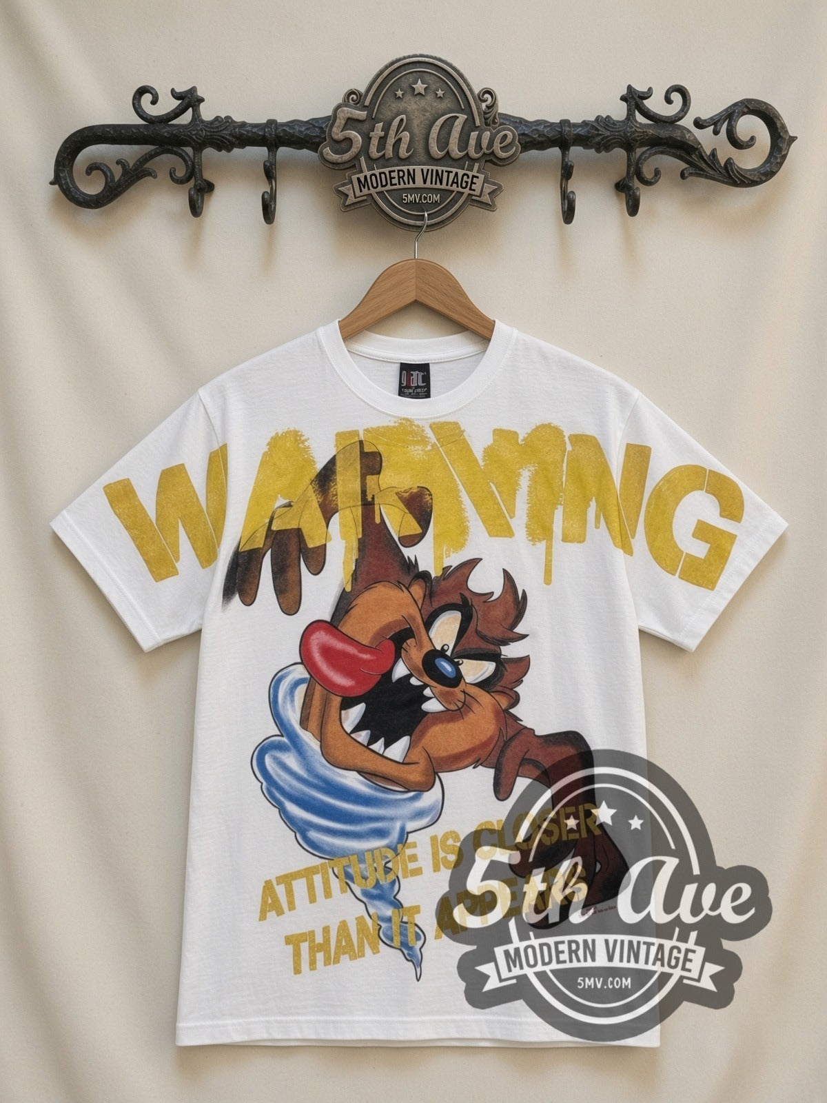 Looney Tunes Taz Warning Attitude Is Closer all-over-print vintage cartoon t-shirt in white, front view on a display rack