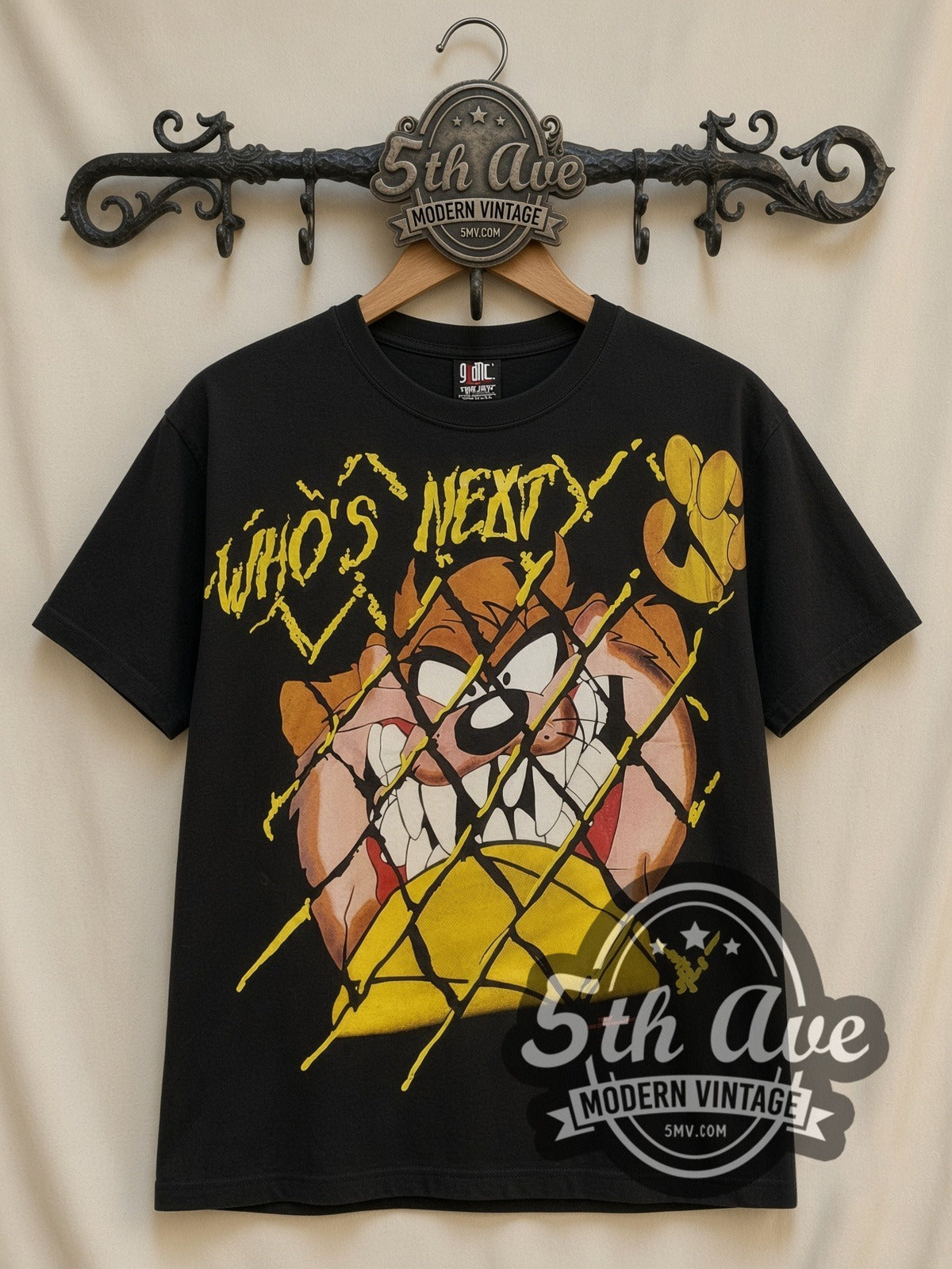 Looney Tunes Taz Who's Next all-over-print vintage cartoon t-shirt in black, front view on a display rack